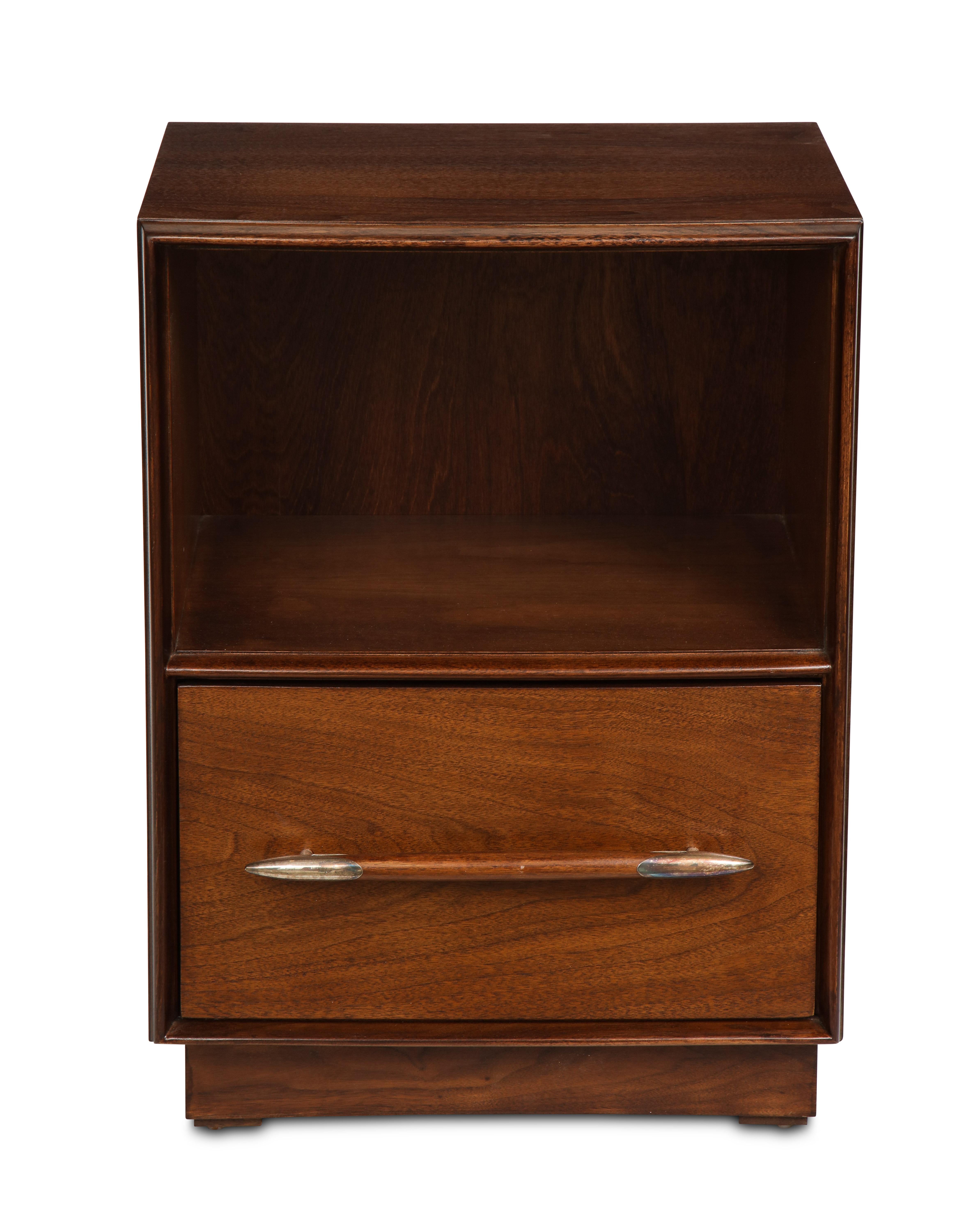 Walnut with polished nickel details. Having an open interior with one lower drawer, with the original label inside the drawer.
  