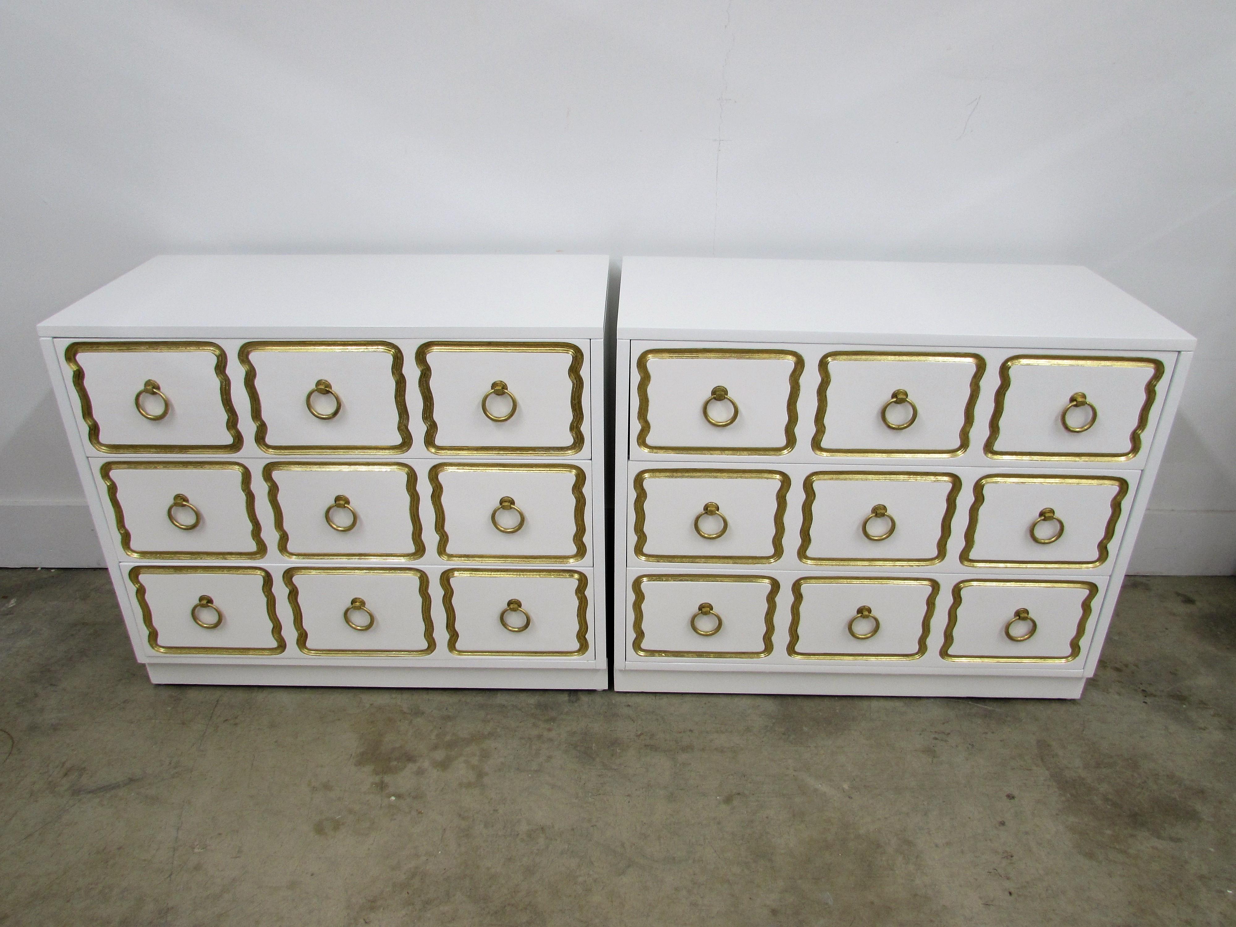 Pair of chests in the manner of Dorothy Draper España Collection for Heritage customized by our In-house Lacquer Studio in Alabaster white with original brass ring pulls and iconic incised framing in hand-applied gold leaf.