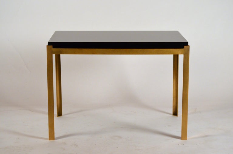 Pair of chic 'Caisson' brass and black lacquer end tables by Design Frères. Solid (not plated) brass frames pared with durable lacquer tops (coasters still recommended). Great as end tables, side tables or even a two-part coffee table.