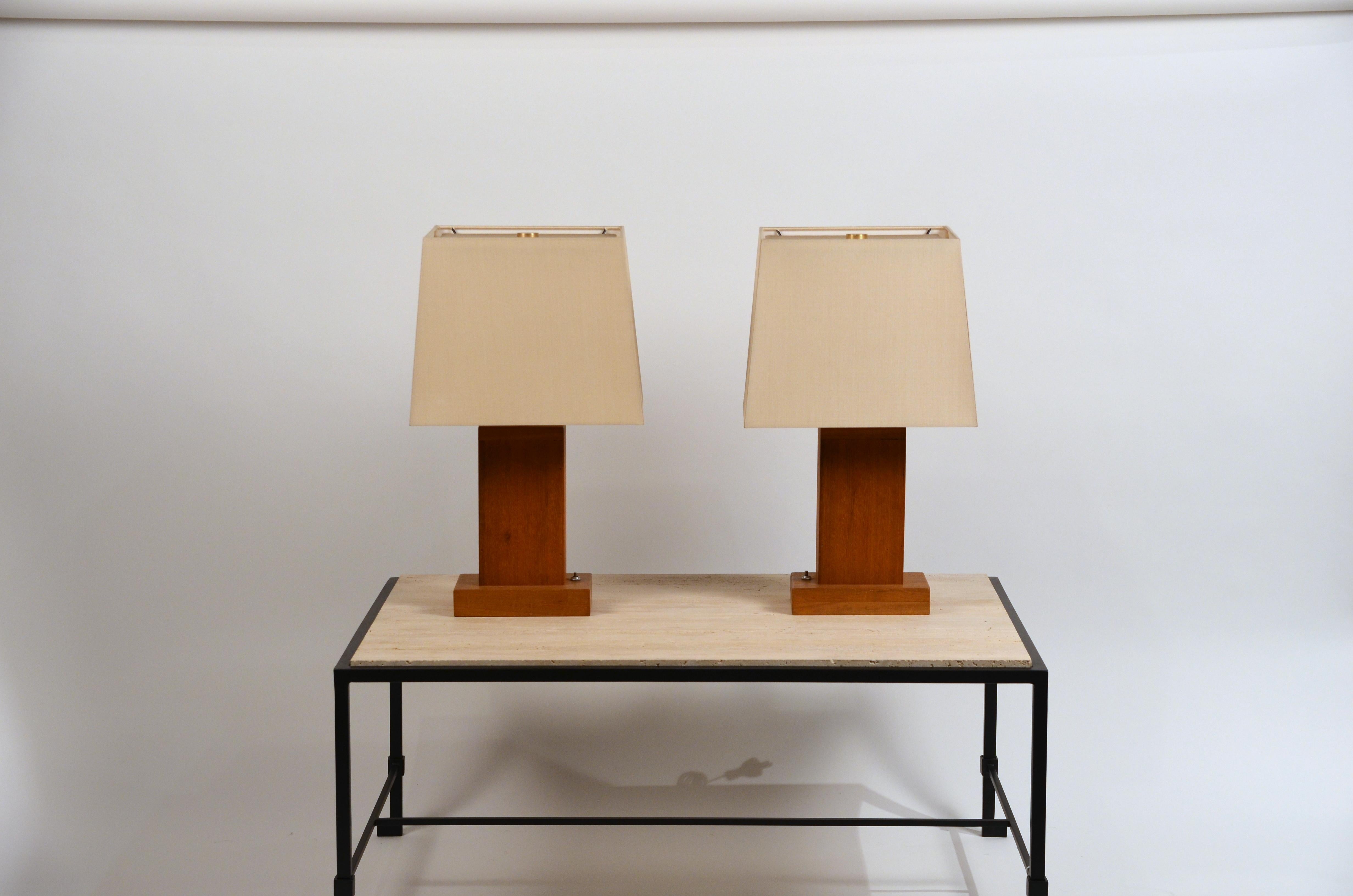 Pair of chic cubist bedside / table lamps with custom silk shades.

Custom made with symmetrical side switches. New custom silk shades with diffusers conceal the bulbs from above.

Overall dimensions: 22 in. tall x 13 in. wide x 10 in. deep. The