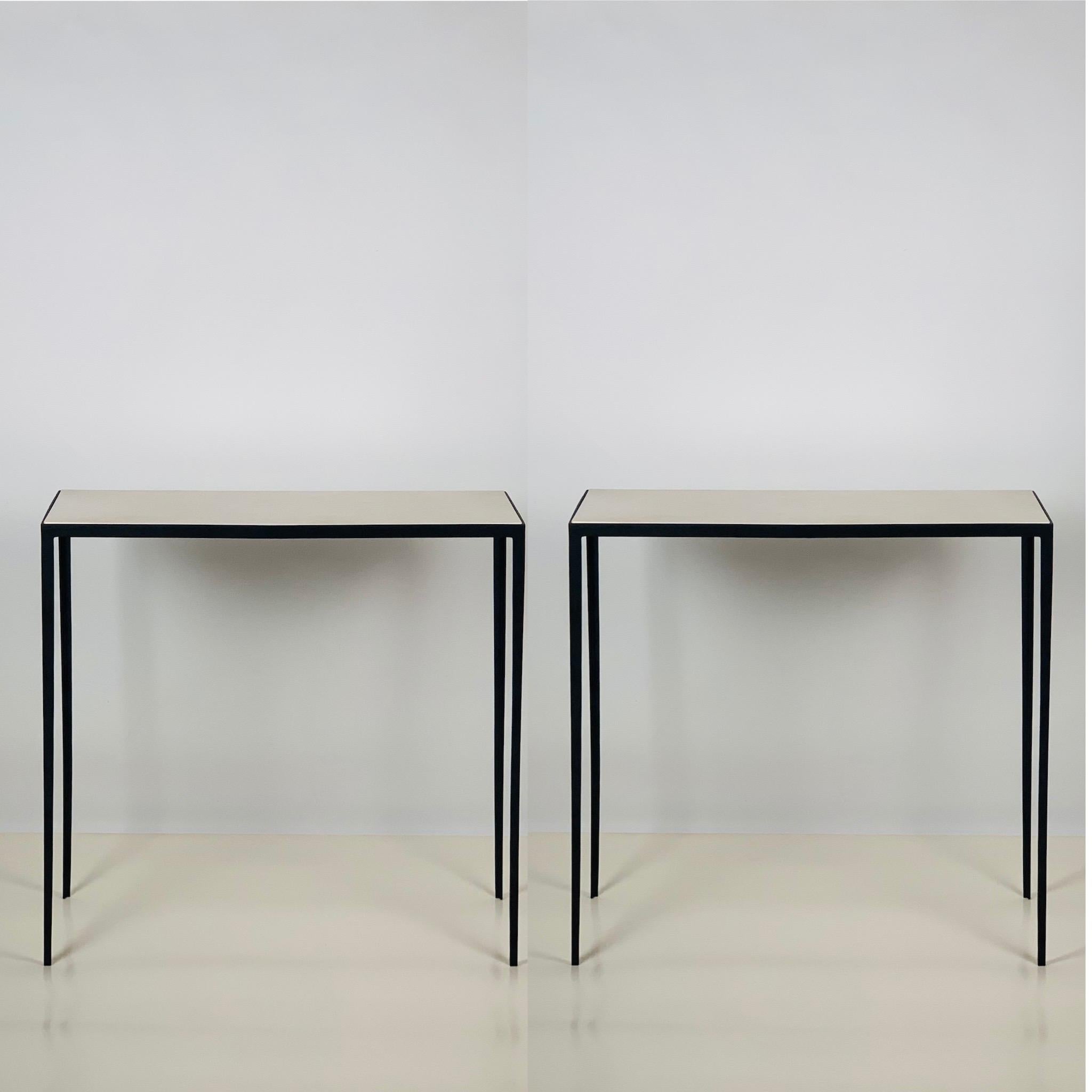 Contrasting grained cream parchment tops over slender blackened steel frames. Beautiful, simple, understated design.

Inspired by the timeless aesthetic of French modern design, these consoles from our exclusive Design Frères line are handmade in