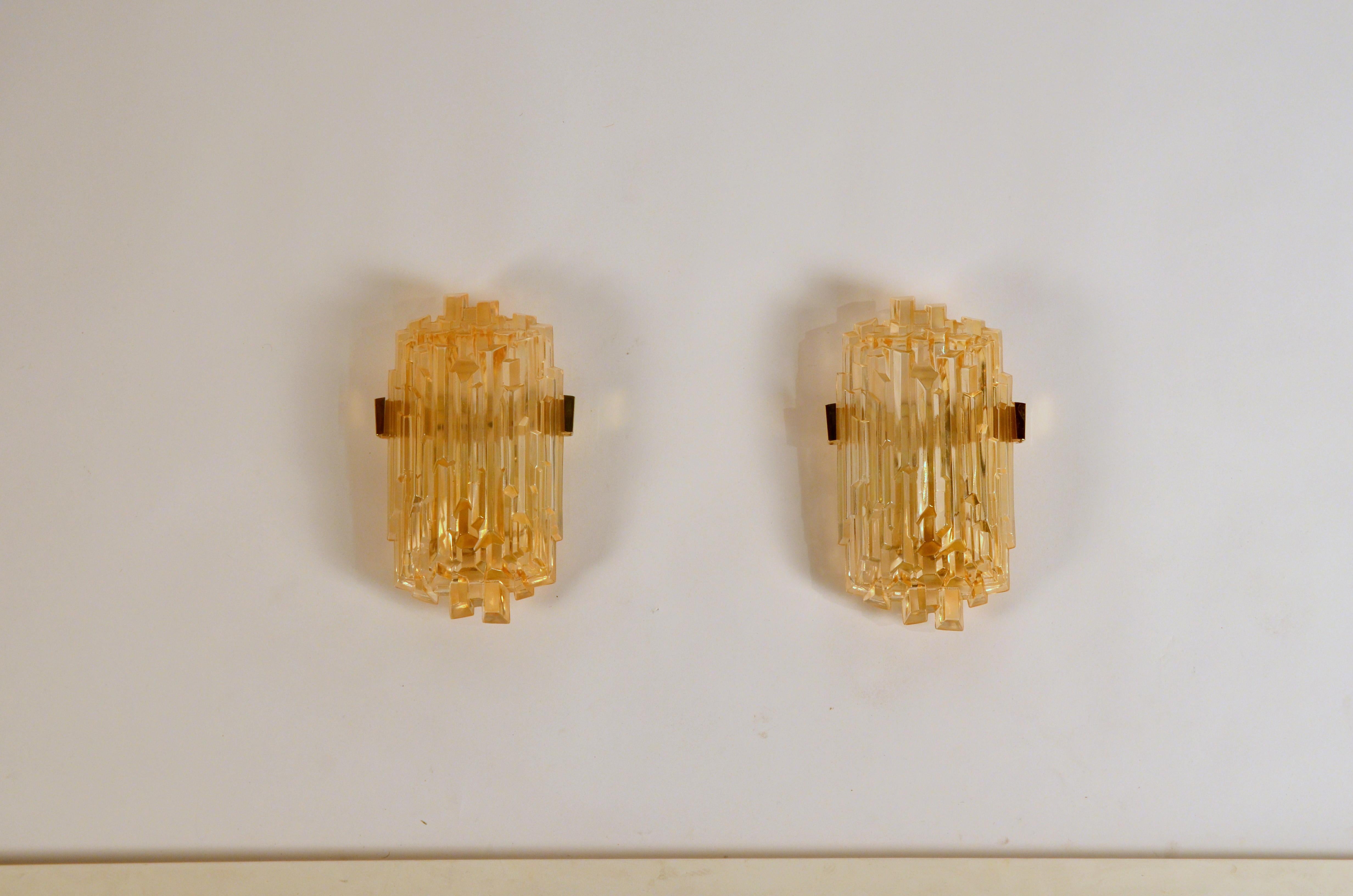 Pair of chic French 1970s Brutalist glass sconces.

Thick molded glass covers insert into discrete plates with brass attachments.

 