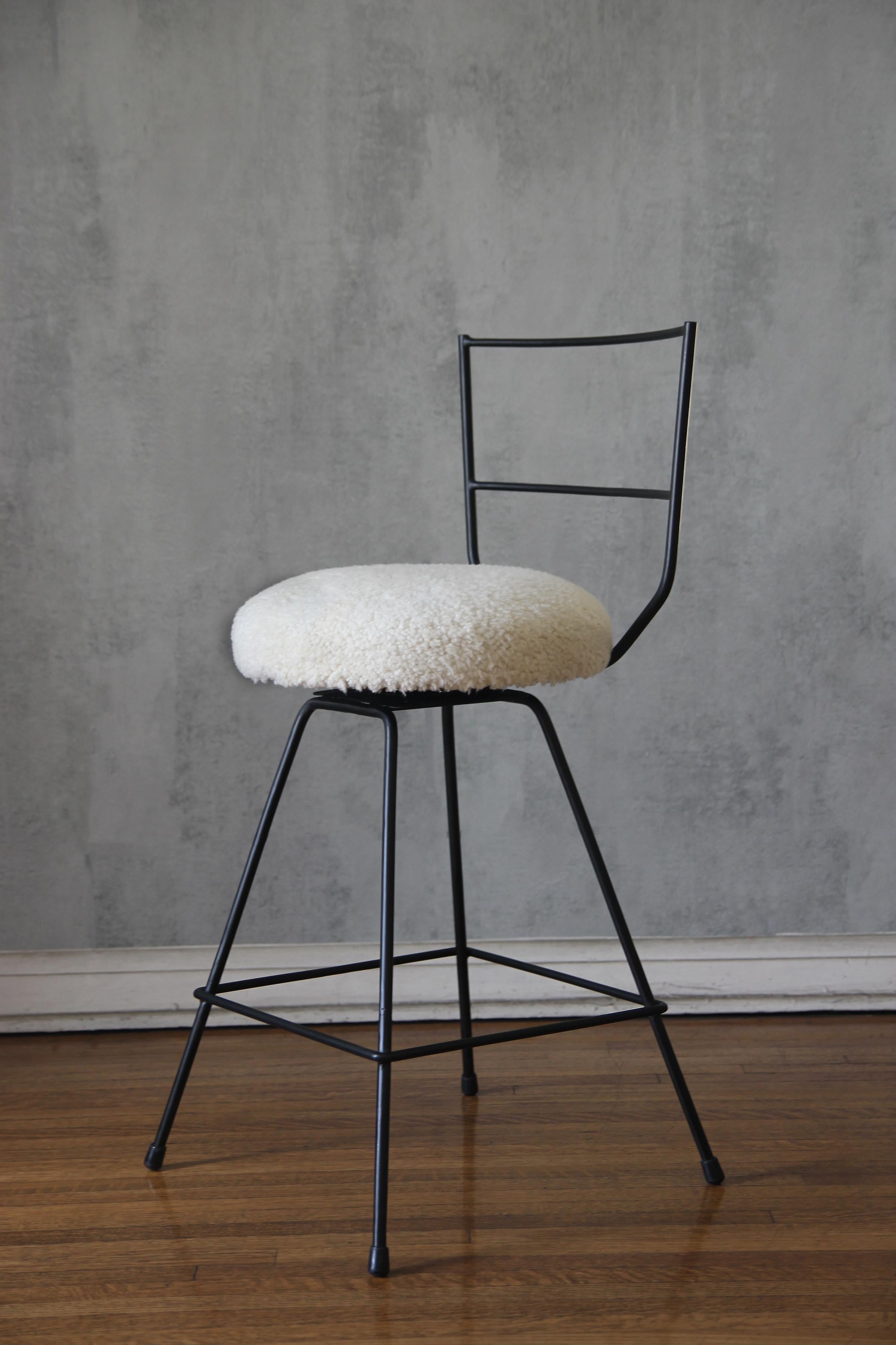 Chic combination of slender but sturdy powder coated steel frames contrast nicely with the natural cream shearling upholstery.

This unique upholstery treatment gives a luxurious feel.

The pair of stools is part of our new understated design