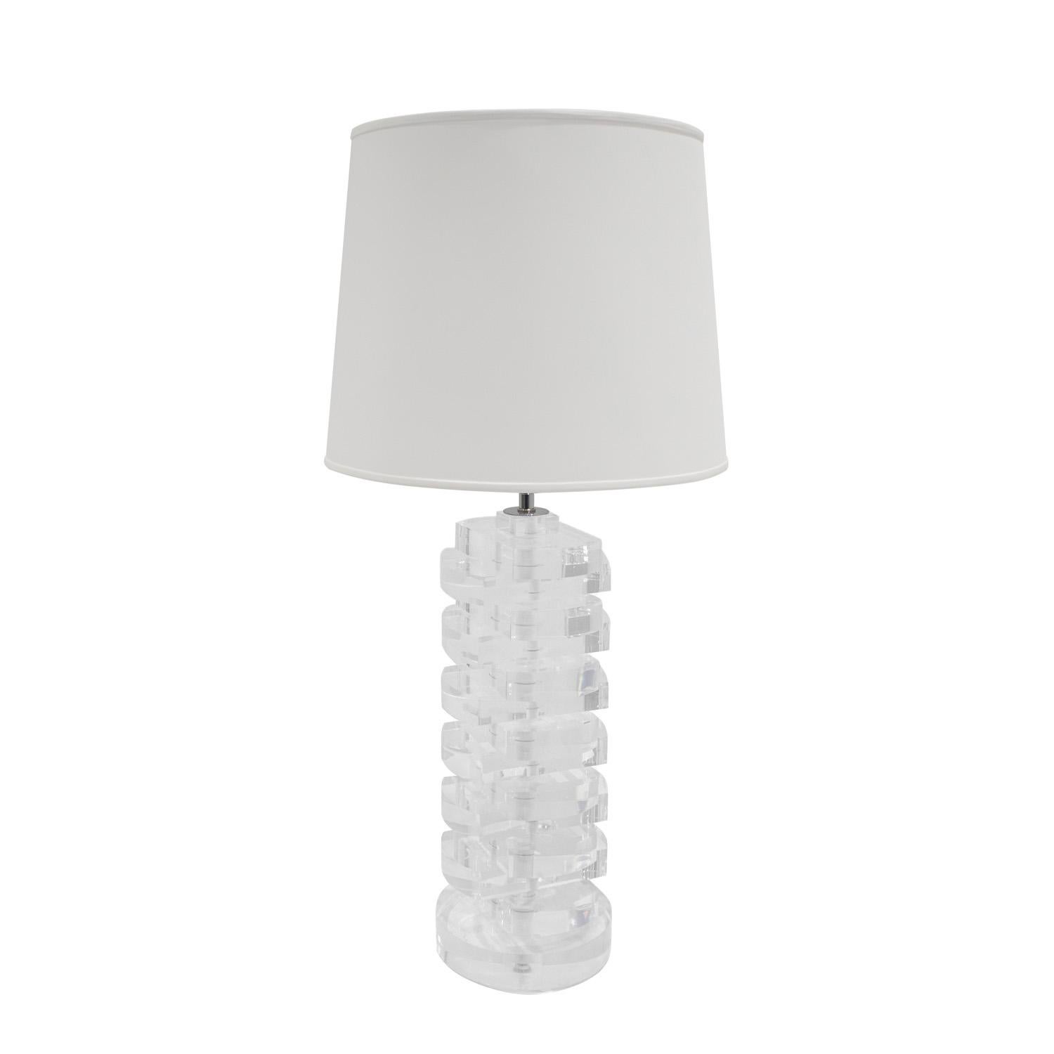 Pair of large beautifully made table lamps composed of stacked solid lucite disks with polished chrome hardware and each with 2 sockets, in the style of Karl Springer, American 1980's. The pair have been newly rewired by Lobel Modern with new