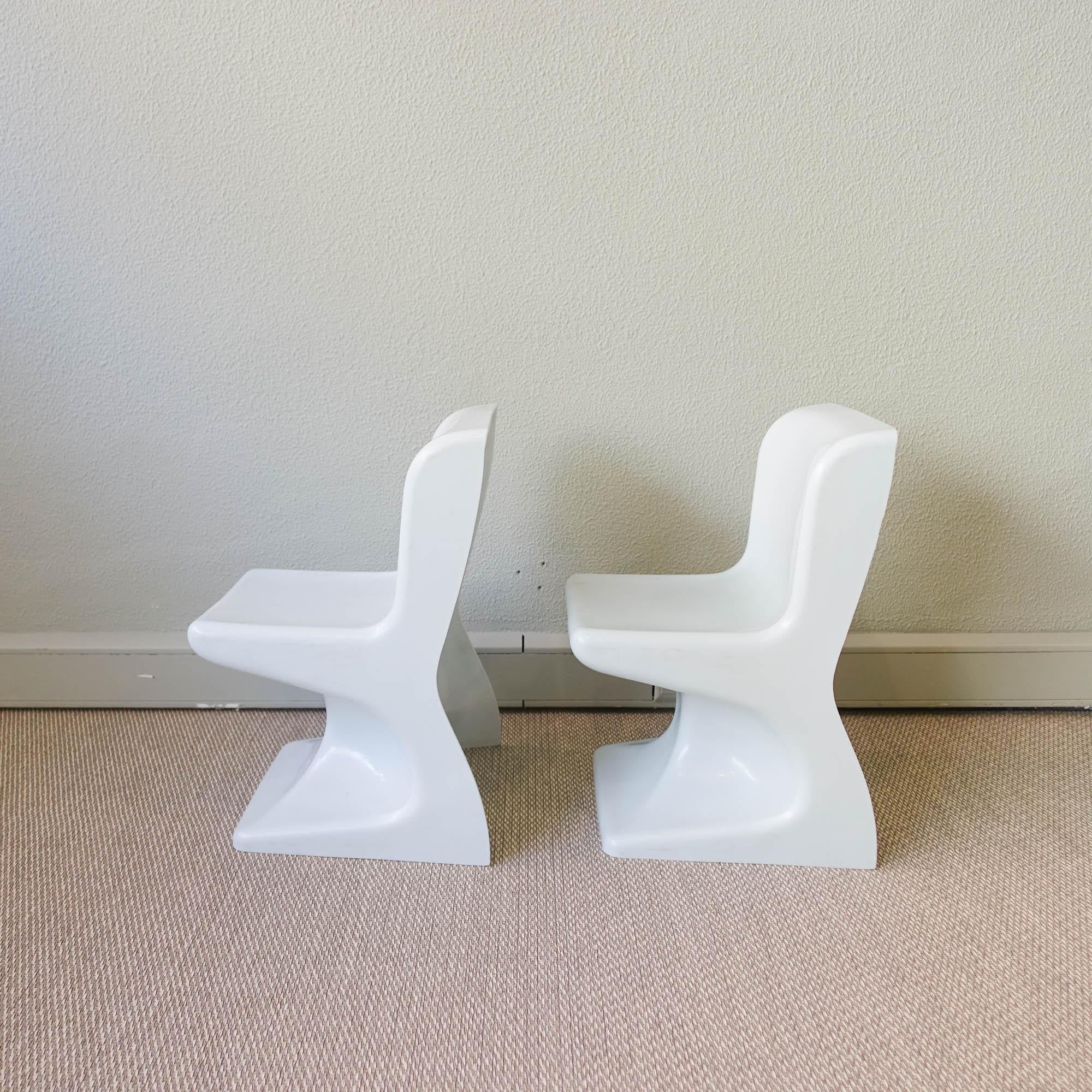 This pair of children's chairs was designed by Patrick Gingembre for SELAP, in France during the 1970's. They are made of white molded plastic with an organic shape very characteristic of Pop Style and 