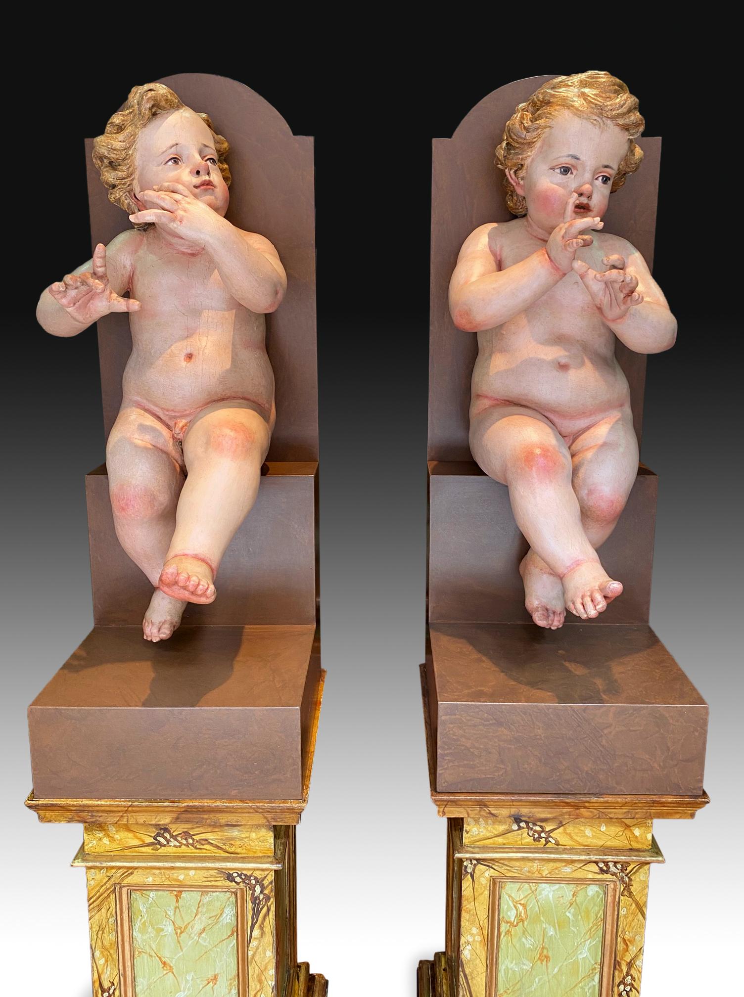 Couple of children. Polychrome pine wood, Century XVIII.
Pair of polychrome pine wood carvings that represent two children in an attitude of playing a musical wind instrument, both seated, with their hands towards their faces, and slightly raising
