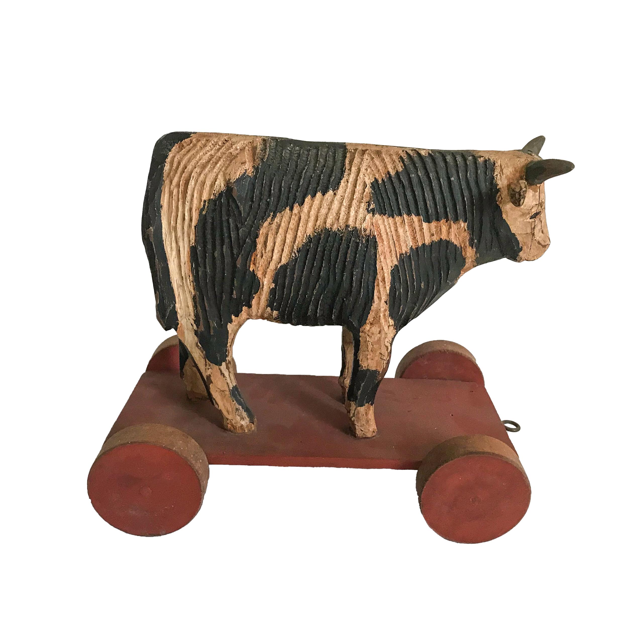 Both the black sheep and cow are carved from pine with original paint
and wooden wheels. Great condition. American, circa 1940-1950.



 