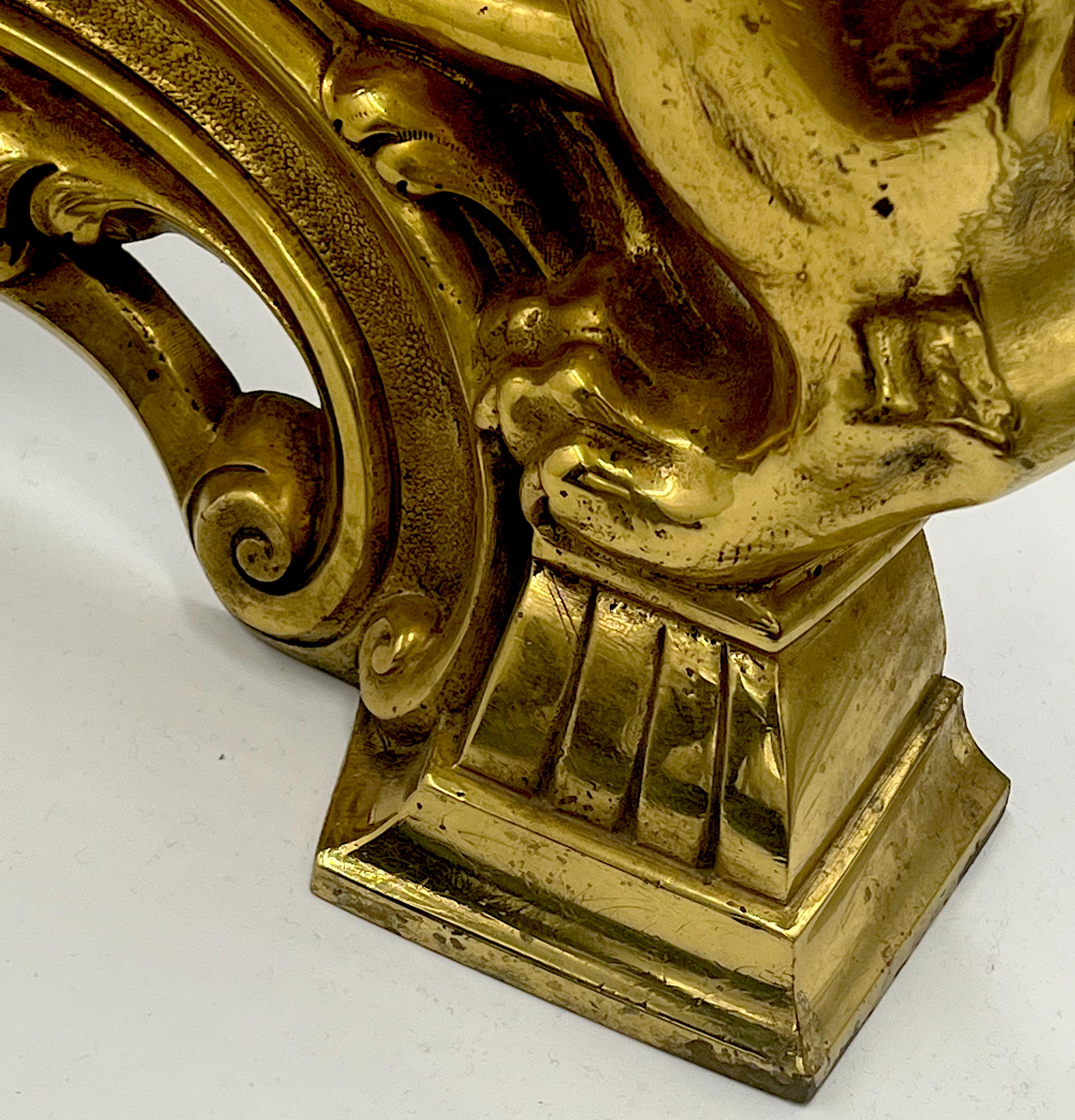 Important pair of gilded and finely chiselled bronze androni in Louis XVI style. They are surmounted by lions reclining on a base depicting a coat of arms of a Tuscan noble family and with trimmings facing the fire pots. The lions are very well