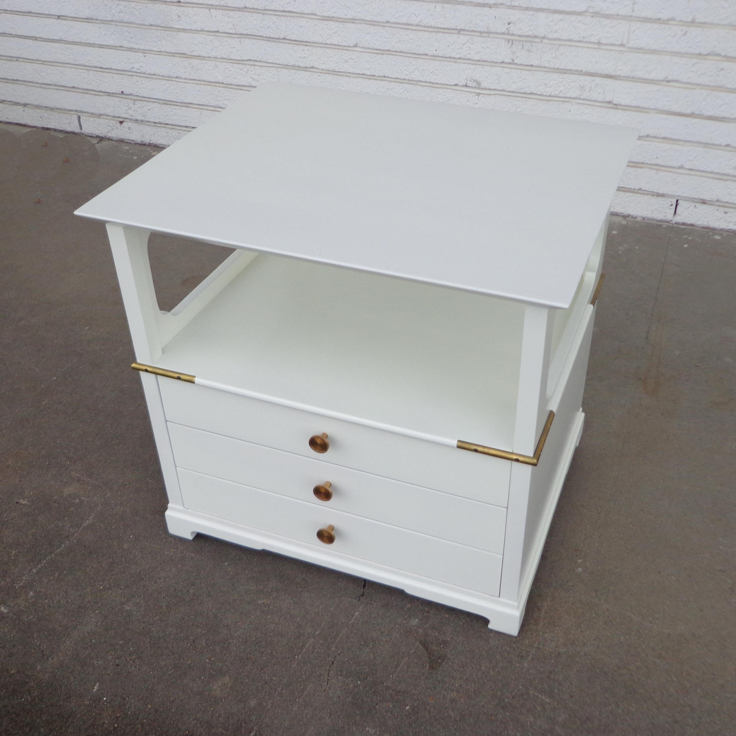 Pair of nightstands by Renzo Rutili for Johnson Furniture Co

Restored in white lacquer over mahogany cases, these stunning two-tier nightstands feature open shelves and 3 drawers. Original brass pulls and wrap around brass details.

We have 2