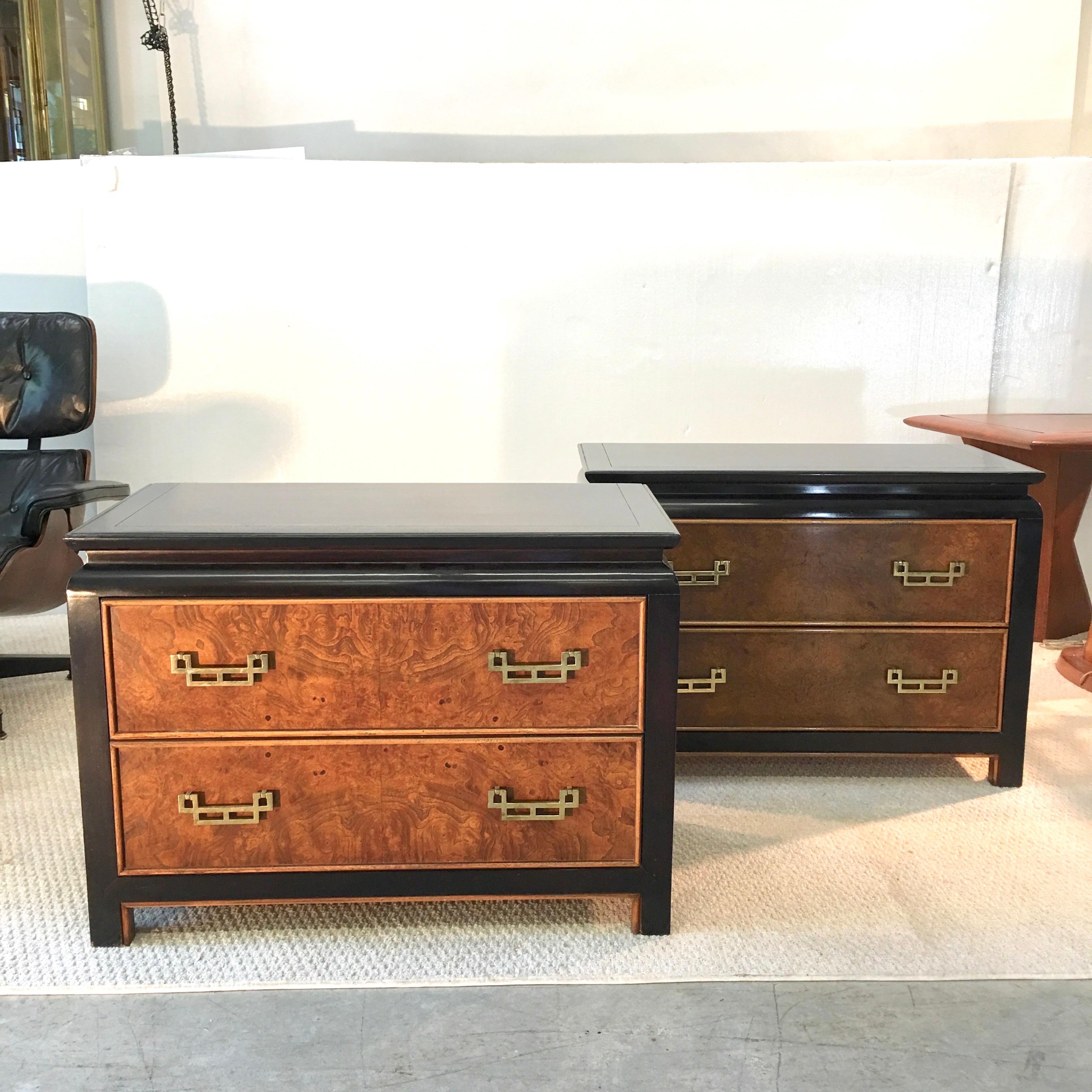 Pair of nightstands from the 1970s Chin Hua collection designed by Raymond Karl Sobota for Century Furniture. Two drawers with distinctive solid brass Asian inspired modernist pulls against burl wood drawer faces and sides on an ebonized case.
