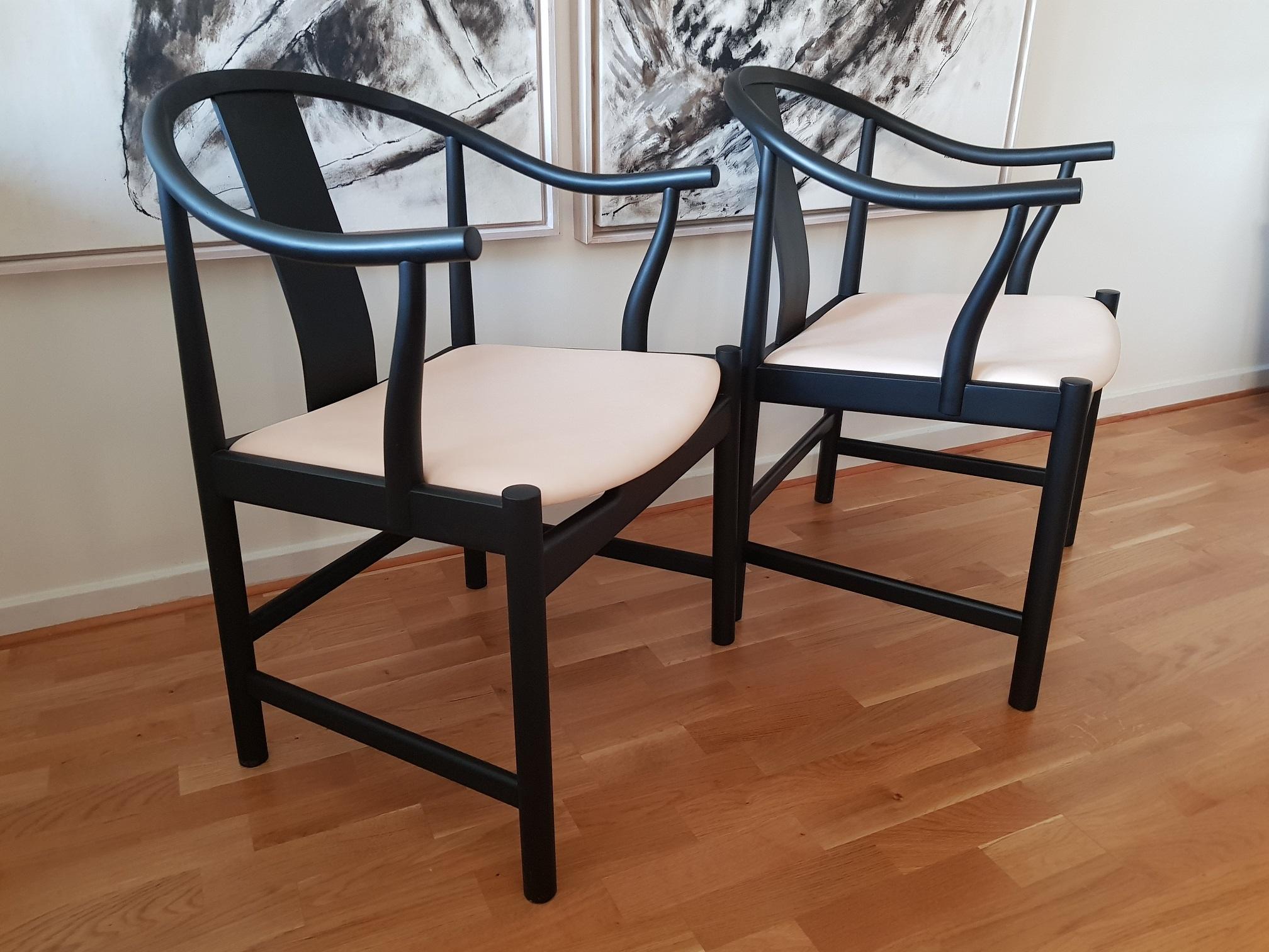 2 China chairs in matt black oak and high quality natural leather. Professionally repainted in cool matt black by the former owner who wanted a personal touch and a set of chairs that nobody else had. Newly upholstered seats in soft natural leather.