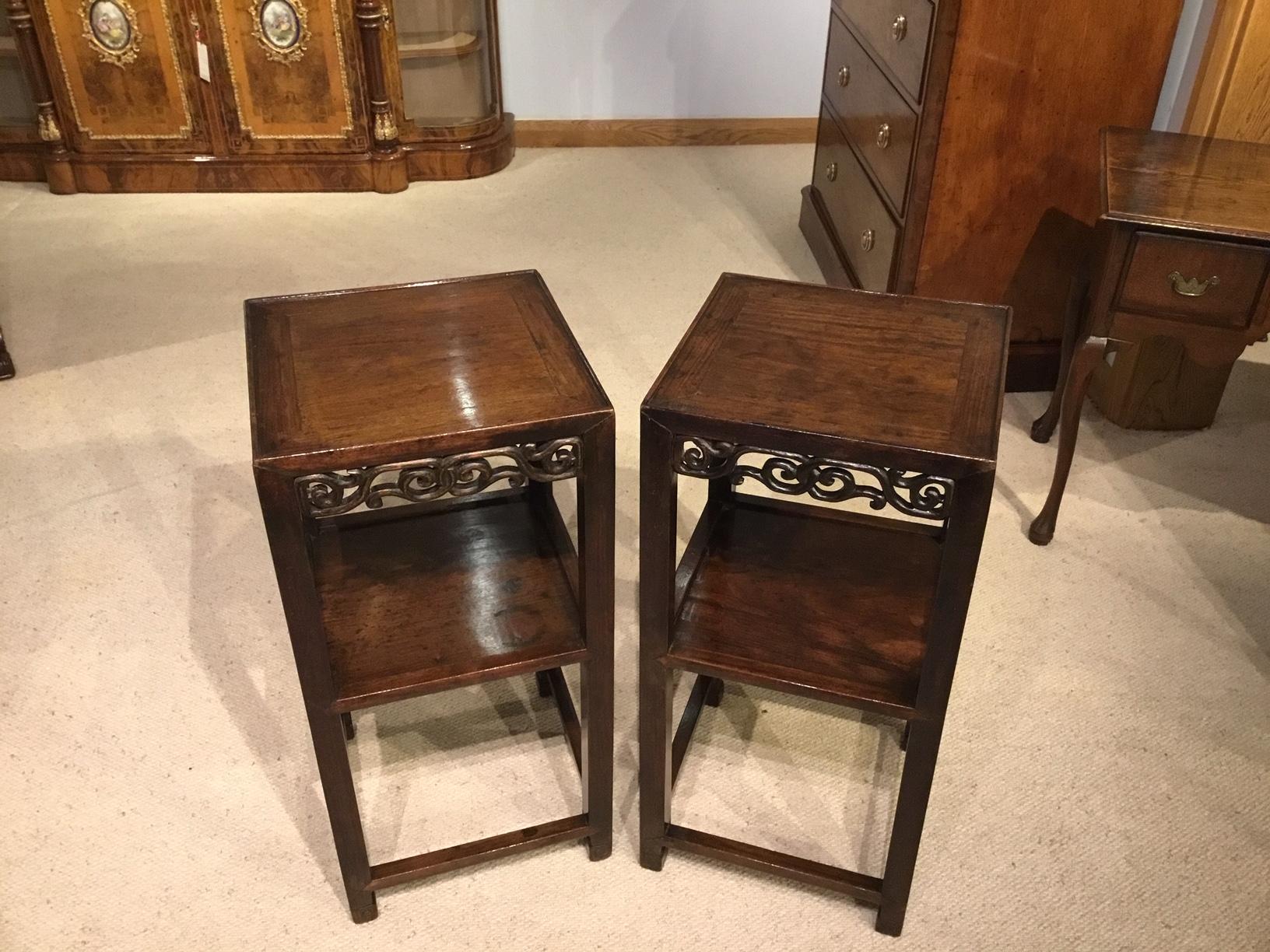 A pair of Chinese 19th century hardwood stands. Each having a square solid hardwood top with typical Chinese pierced frieze and lower shelf. Supported on square supports with stretchers. Chinese, circa 1880.

Dimensions: 14.5