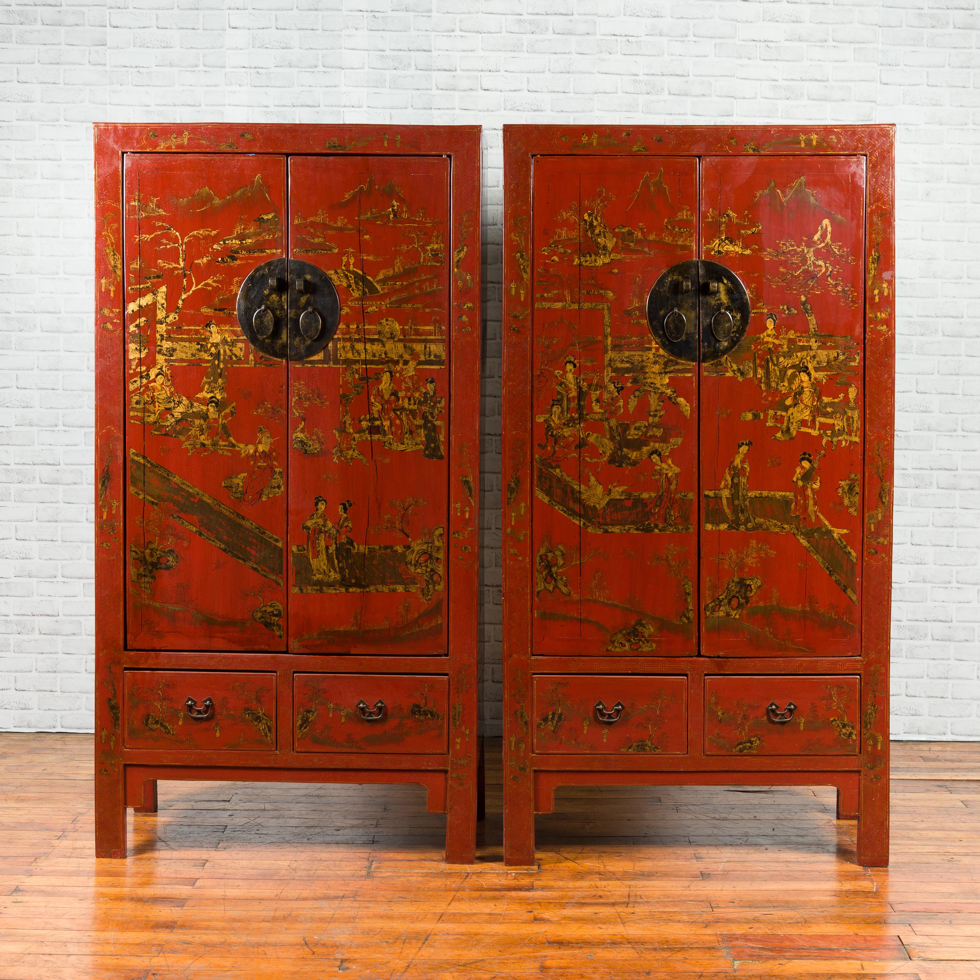 A pair of medium size Chinese Qing dynasty period red lacquered cabinets from the 19th century, with gilt chinoiserie décor and hidden drawers. Born in China during the Qing dynasty, each of this pair of cabinets features two doors, adorned with