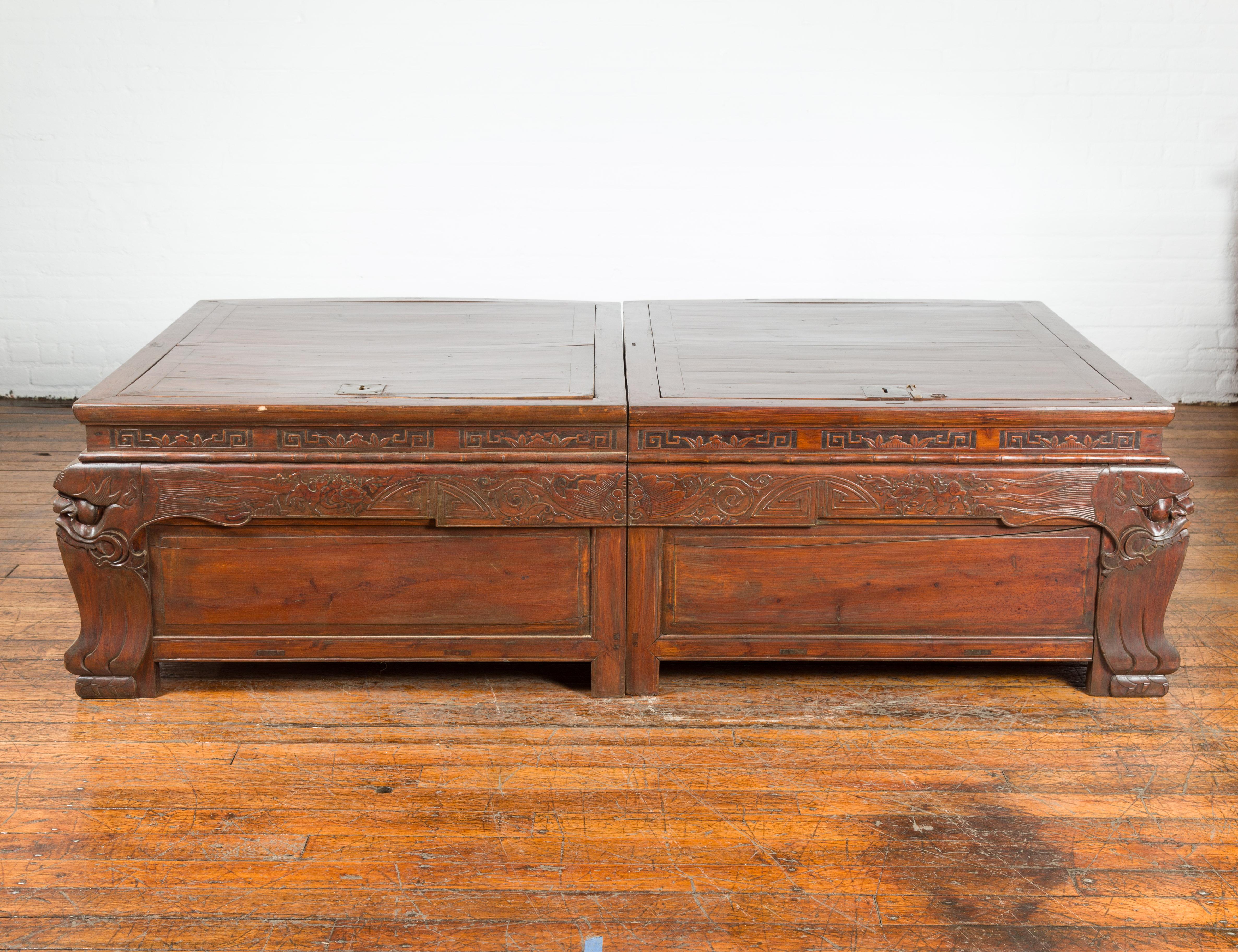 A pair of Chinese antique unusual chests with locks and carved legs from the 19th century, made into a coffee table. Created in China during the 19th century, these unusual chests can be put together to create a long coffee table. Adorned with