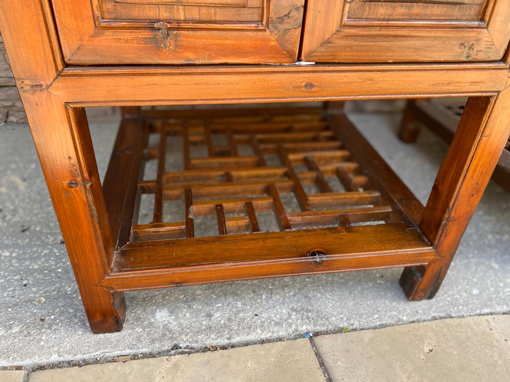 Two Chinese bedside tables (sold as a pair) hardwood with 2 drawers, 2 doors, and storage shelf underneath having a hoof foot. Square in shape, may also be used in a living room.