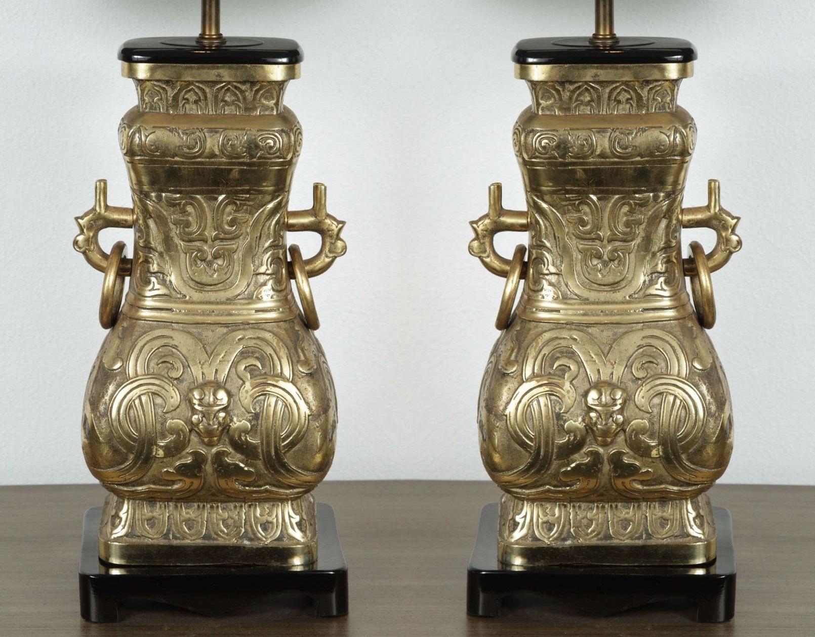 An impressive pair of chinoiserie-inspired brass table lamps in the manner of Hollywood Regency designer James Mont. Traditional form being a fang (square) interpretation of hu and gui archaic ritual bronzes from the Shang and Zhou dynasties. Such