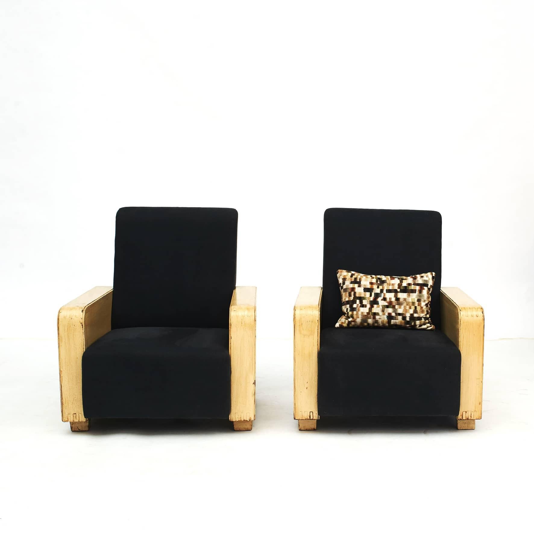 Pair of decorative Chinese art deco easy chairs. The straight wooden armrests with yellow lacquer creates an expressive contrast with the subtle black linen fabric upholstery.
The original yellow lacquer remains in a very good vintage condition and