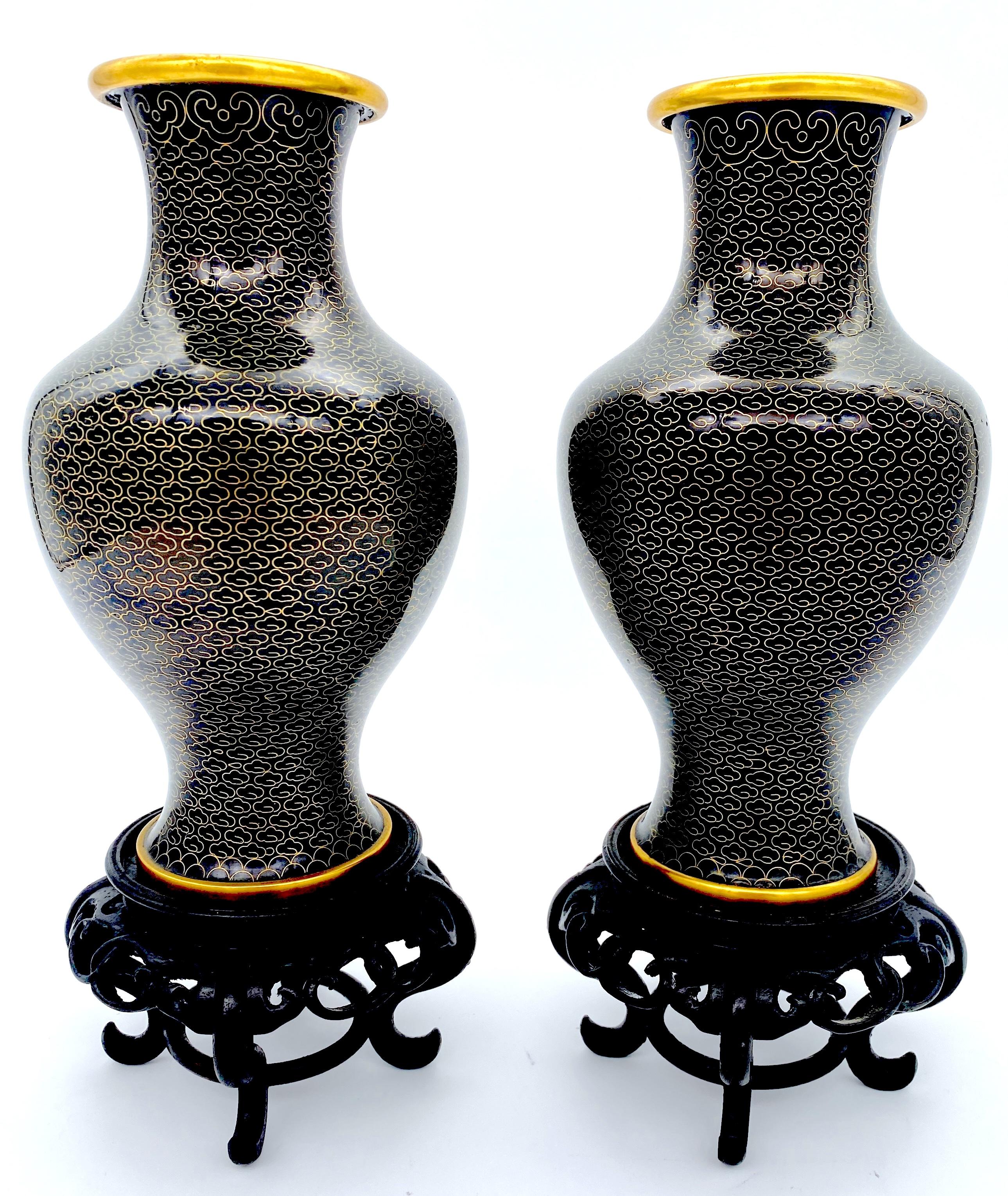Pair of Chinese Black & Gilt Brass Fish Scale Cloisonné Vases, with Stands 
China, circa 1980s

This elegant pair of Chinese black and gilt brass fish scale cloisonné vases, dating to the 1980s, highlights the timeless blend of traditional