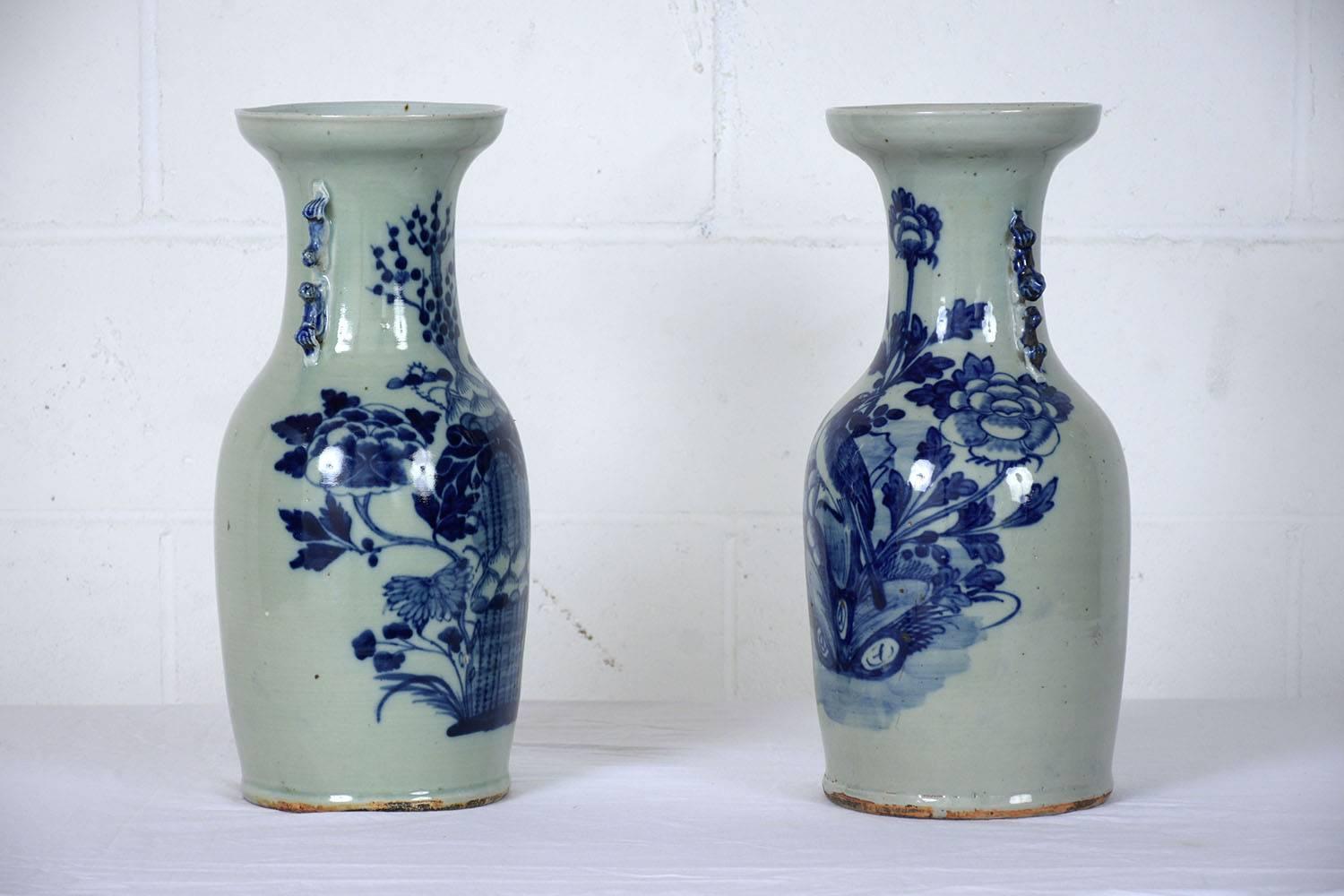 This Pair of 1930s Chinese vases are made of ceramic with a white and blue color finish. Adorning the vases are scenes of gardens with flowers, leaves, trees, and even a bird. This pair of vases is sturdy, stunning, and ready to decorate any room