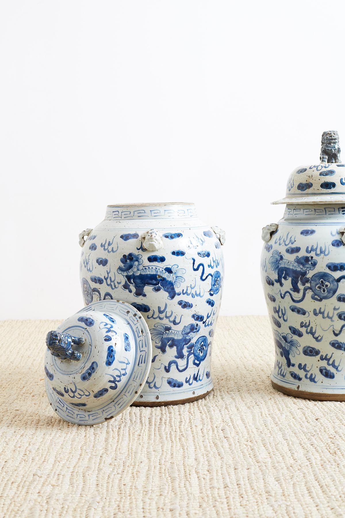 20th Century Pair of Chinese Blue and White Ginger Jars with Foo Dogs