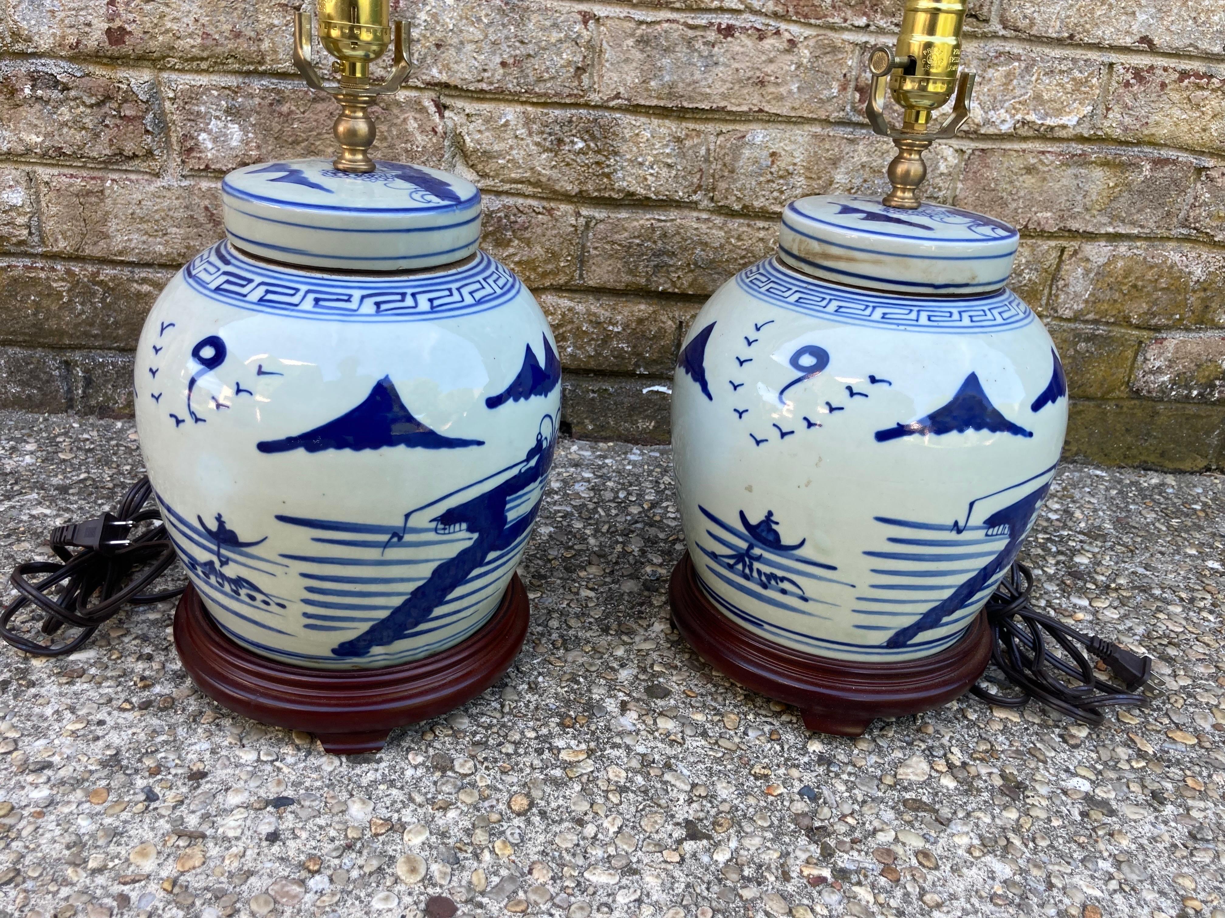 Lovely pair of Chinese blue and white jars with lids made into lamps with a teak base.