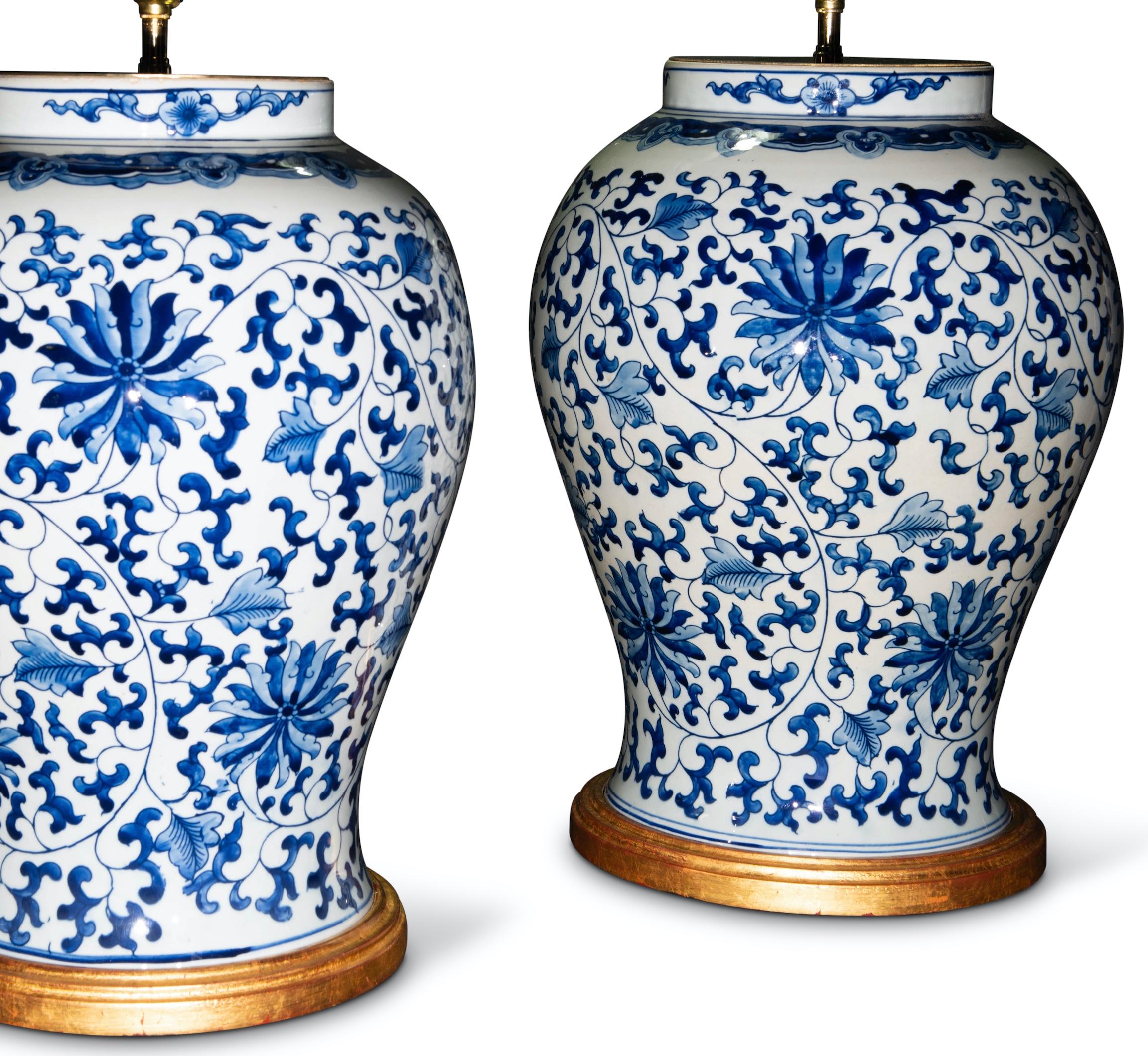 20th Century Pair of Chinese Blue and White Lotus Flower Porcelain Table Lamps For Sale