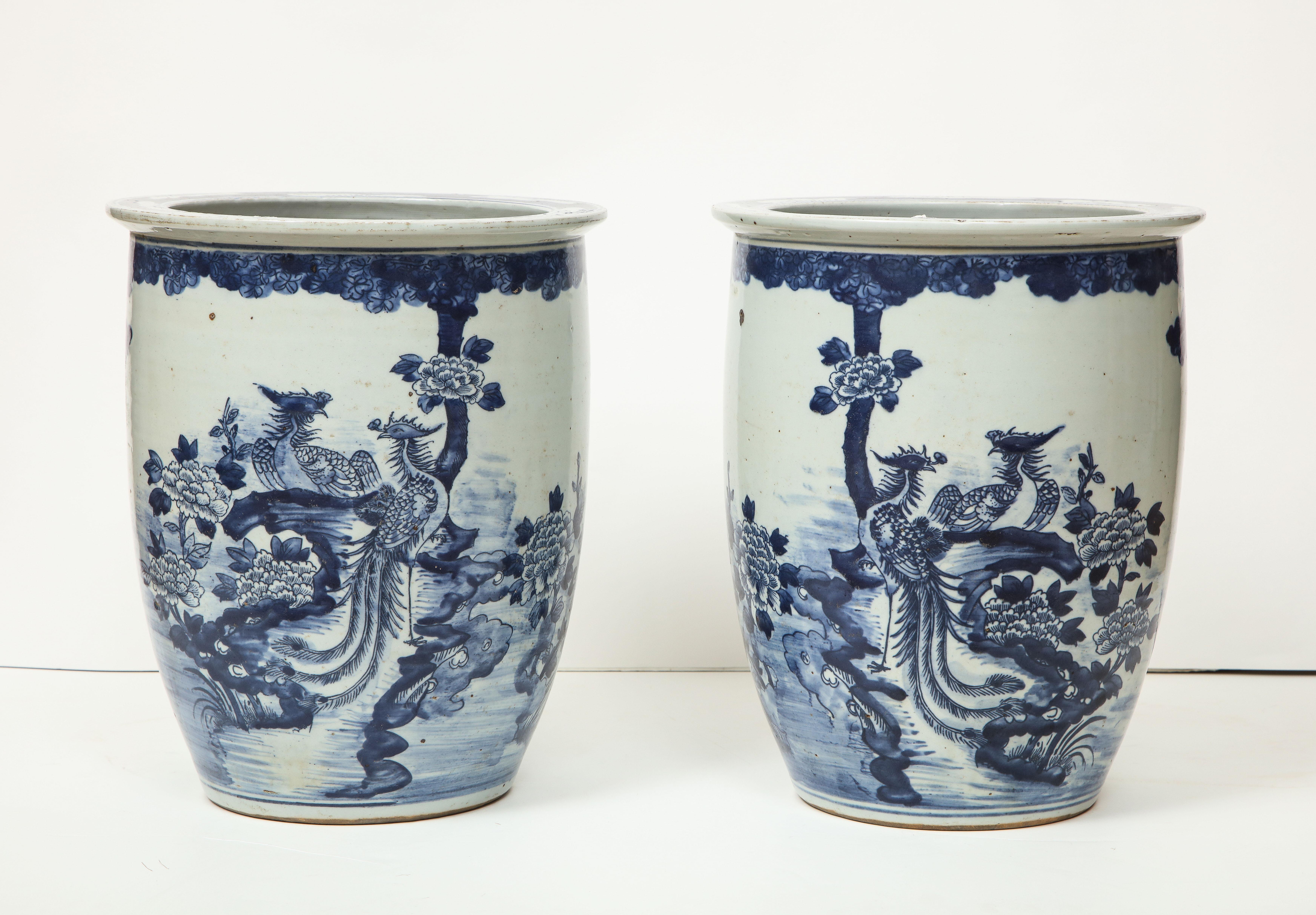 Blue and white goes with everything, and will never go out of fashion. These two Chinese export vases/cachepots look great as stand alone pieces or as vessels for flowers or plants. One side is more heavily decorated, while the other side features a