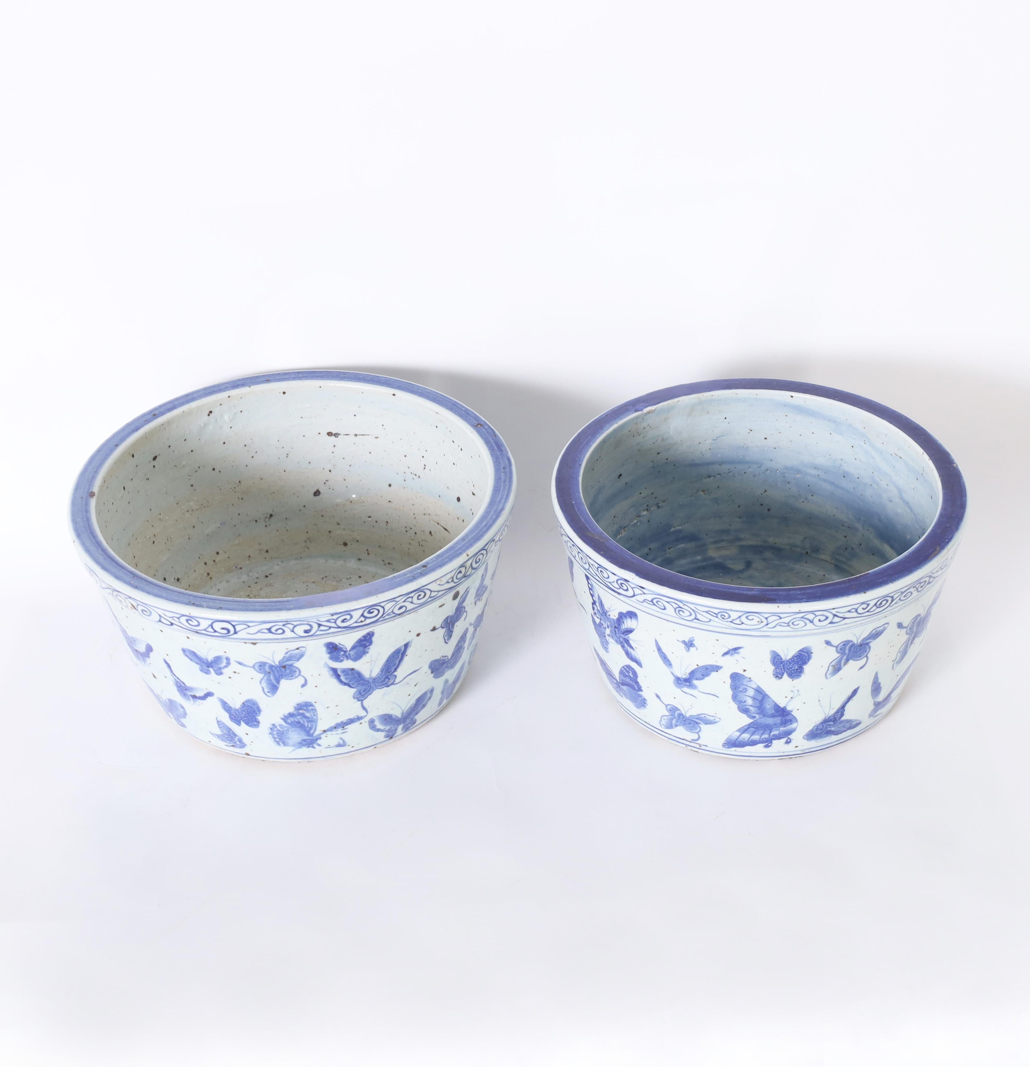 Charming pair of Chinese blue and white porcelain bowls hand decorated with butterflies and moths, perfect for orchid arrangements. 