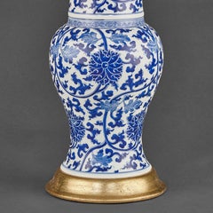 Pair of Chinese Blue and White Porcelain Fish Tail Lamps on Gilt Bases.