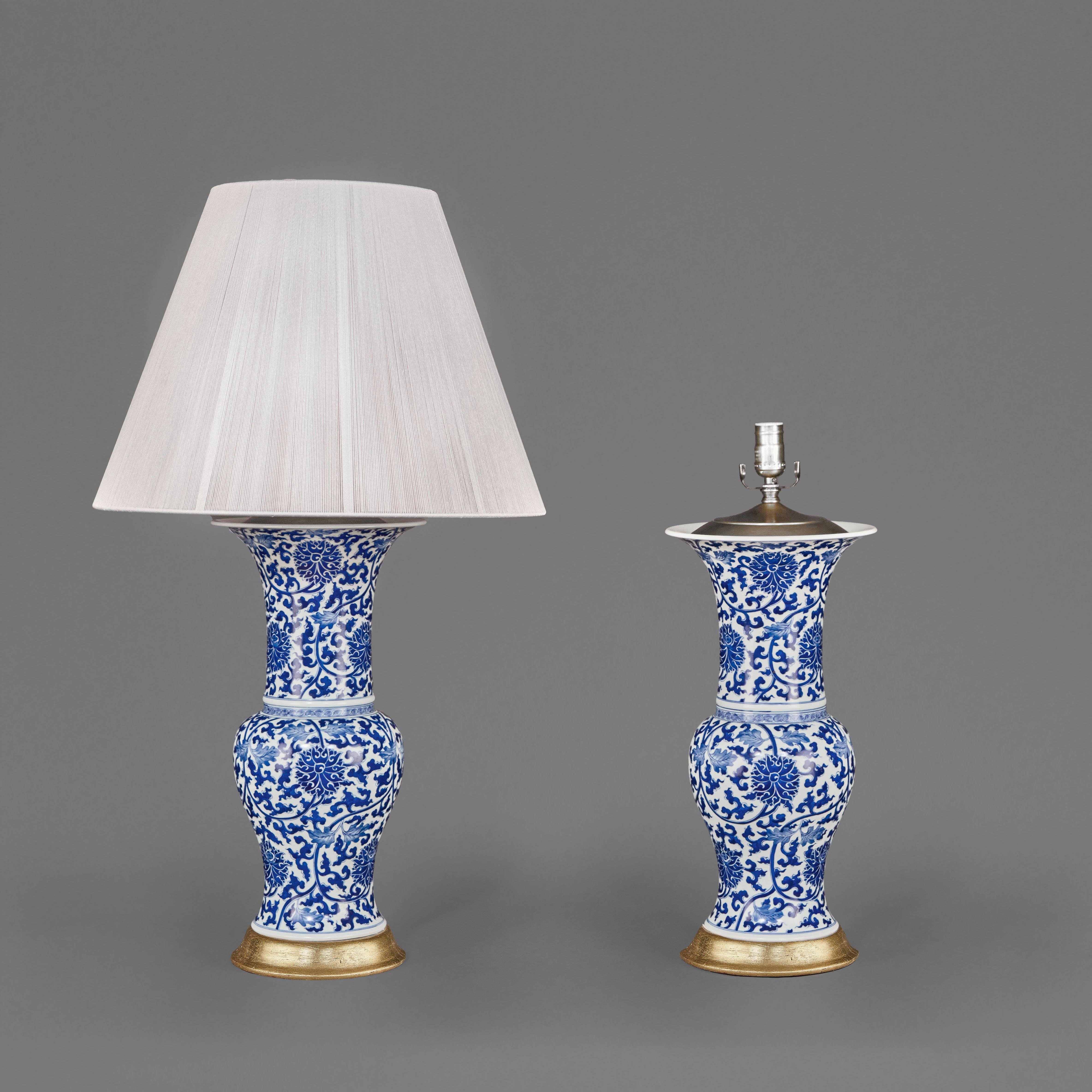 Chinese Export Pair of Chinese Blue and White Porcelain Fish Tail Lamps on Gilt Bases. For Sale