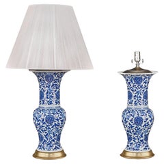 Pair of Chinese Blue and White Porcelain Fish Tail Lamps on Gilt Bases.