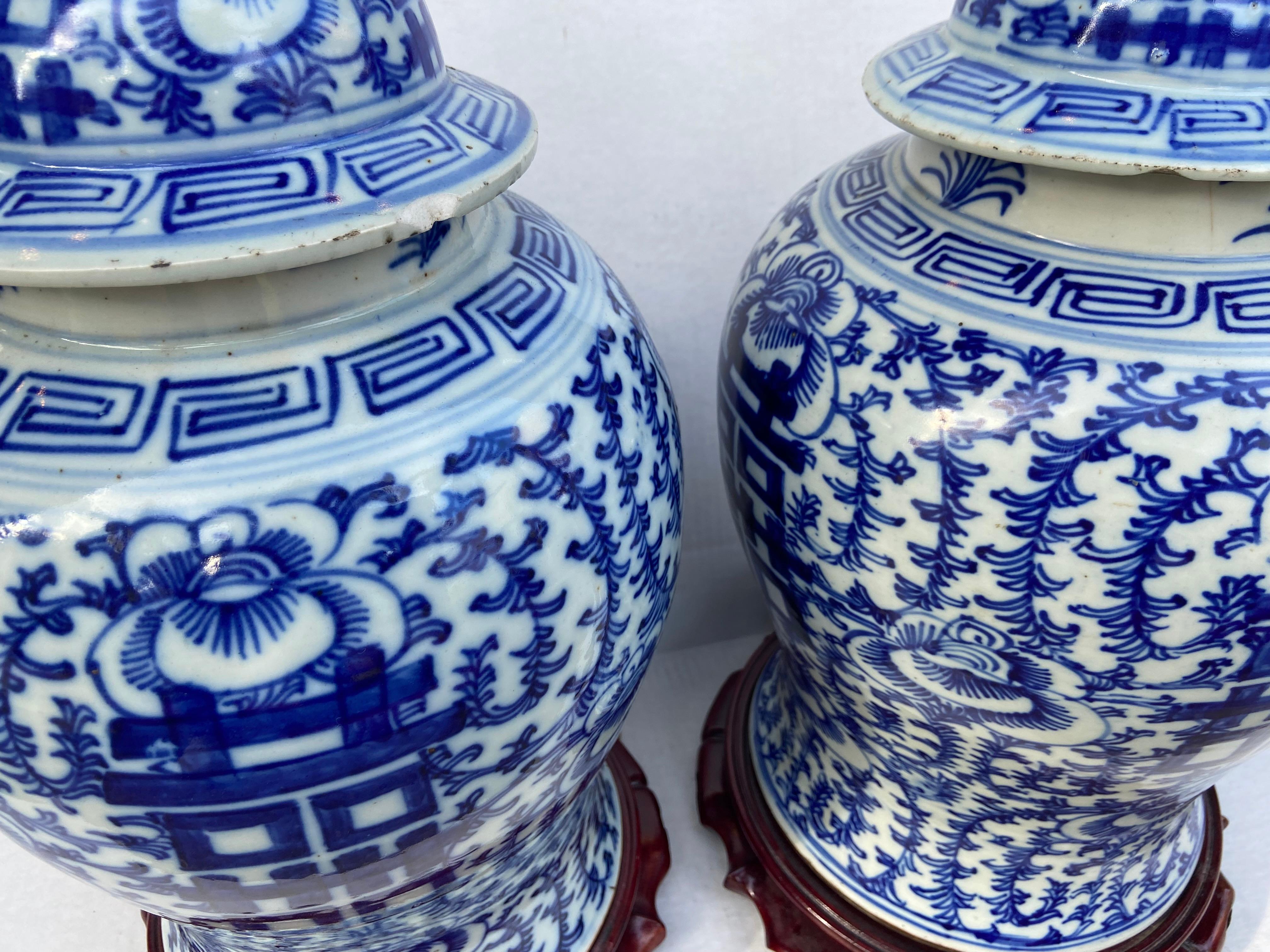 Pair of Chinese blue and white porcelain ginger jar lamps. With Double Happiness (commonly used as a decoration symbol of marriage) painted all around. Rosewood carved bases. 22