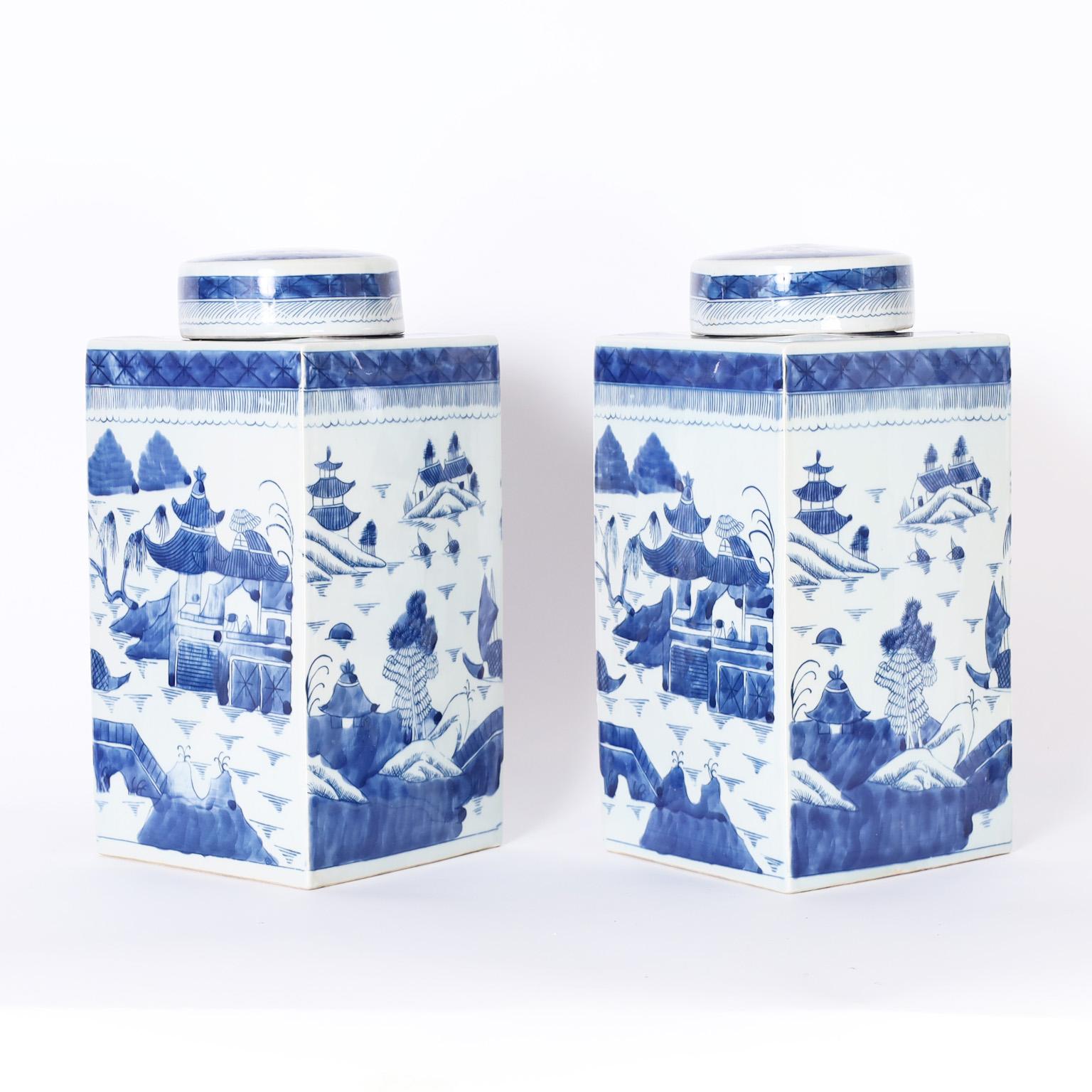 Charming pair of Chinese blue and white porcelain lidded rectangular tea caddies or jars hand decorated with pagodas and landscapes.