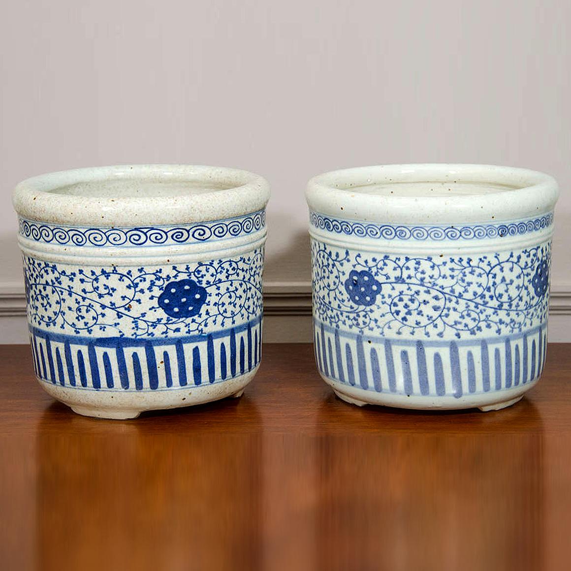 Pair of Chinese Blue and White Porcelain Planters. Ornamented in cobalt with floral and geometric motifs.