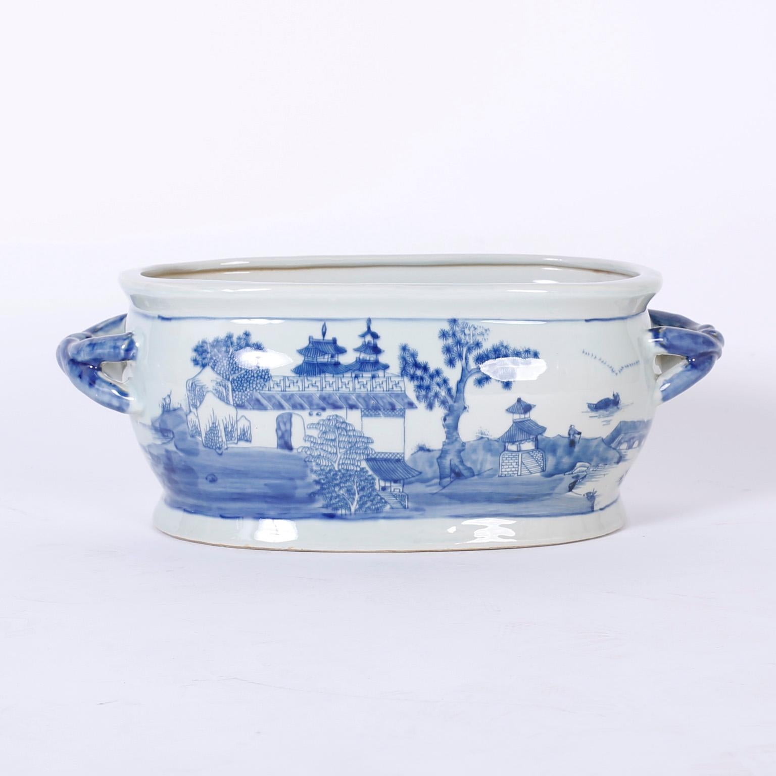 Lofty pair of Chinese blue and white Chinese export style porcelain pots hand decorated on both sides with symbolic chinoiserie landscapes and having unique twisted handles. Perfect for orchid arrangements.