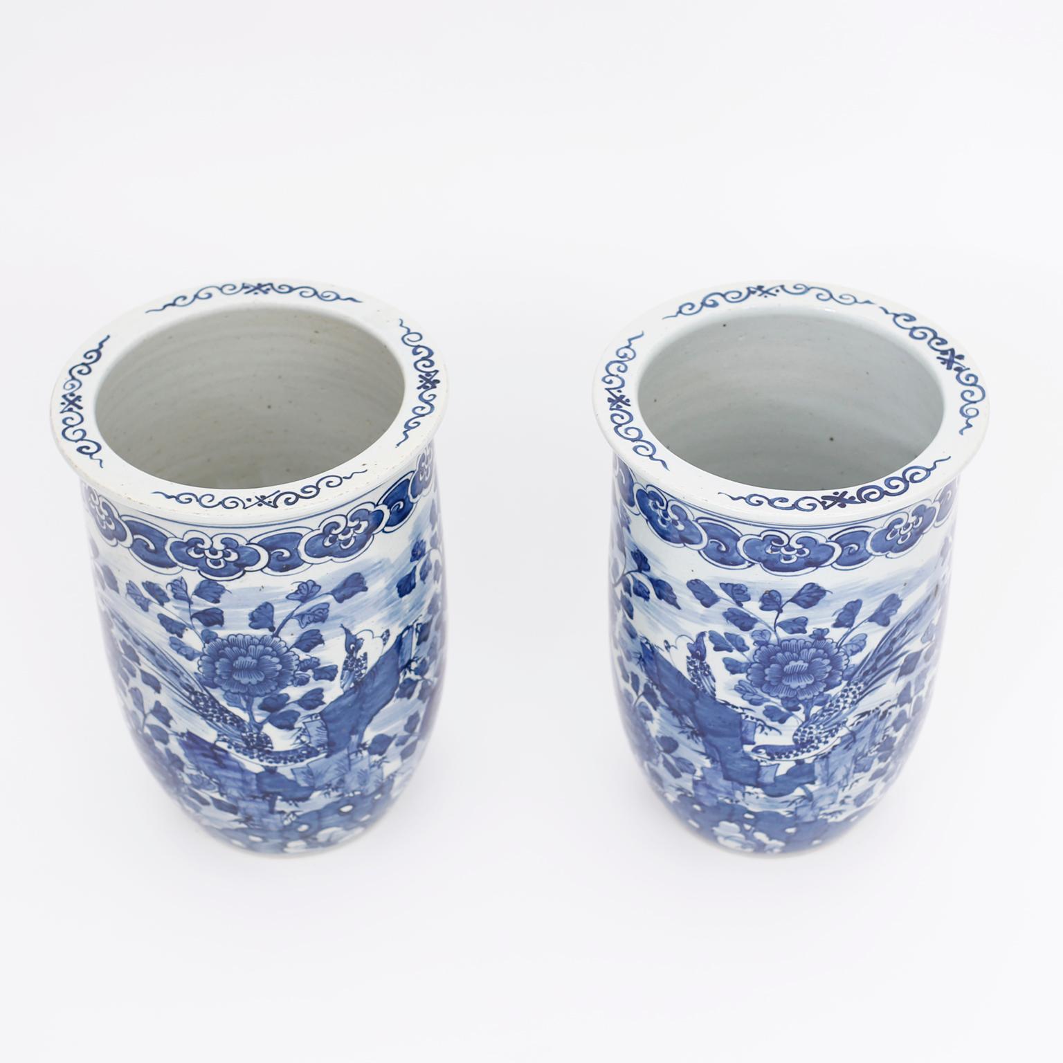 Pair of Chinese blue and white porcelain vases with classic form, in the Chinese Export manner and hand decorated all around with flowers and birds.