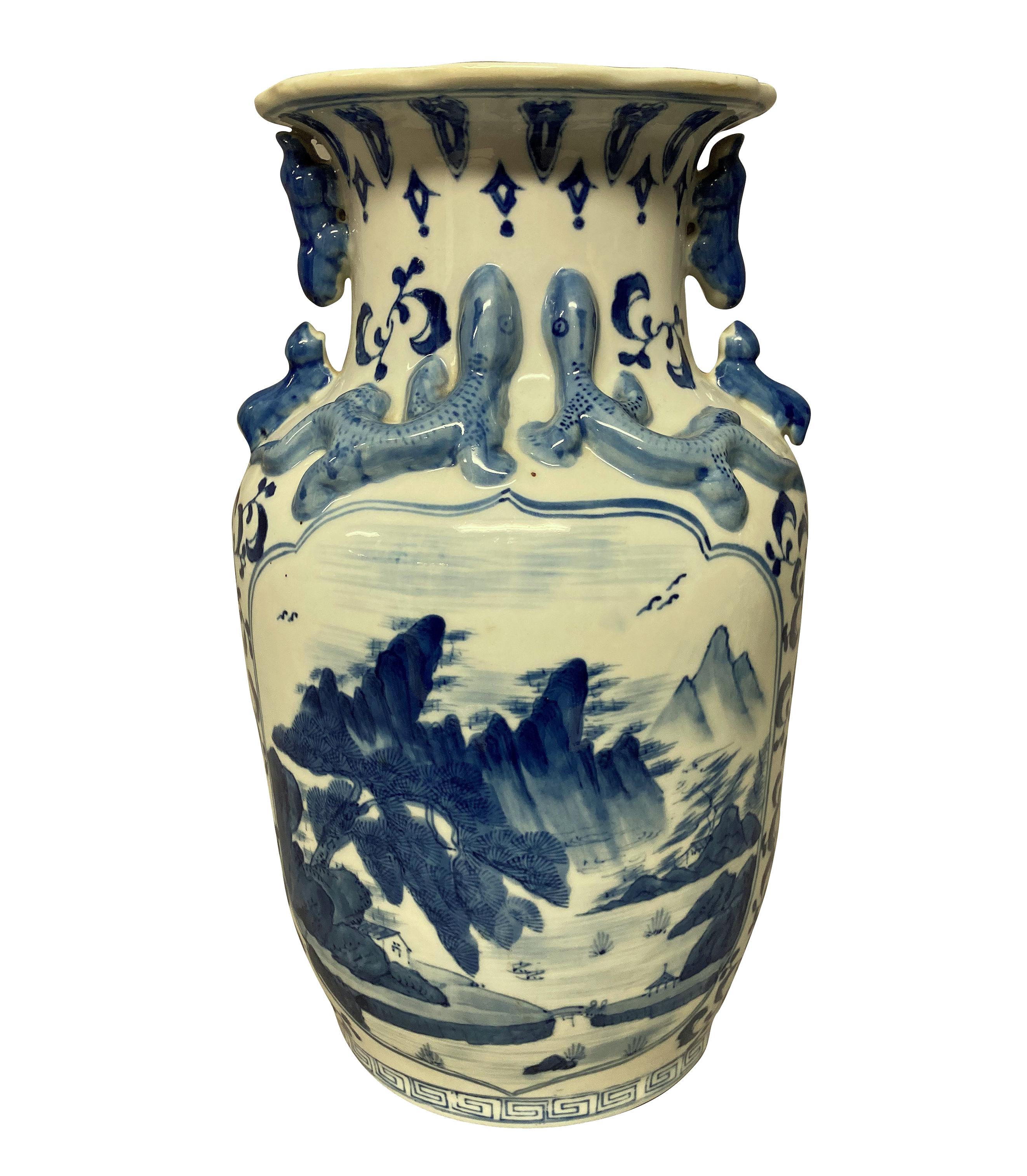 A pair of Chinese blue and white, hand painted porcelain vases. With mountain scenes and salamander decoration.