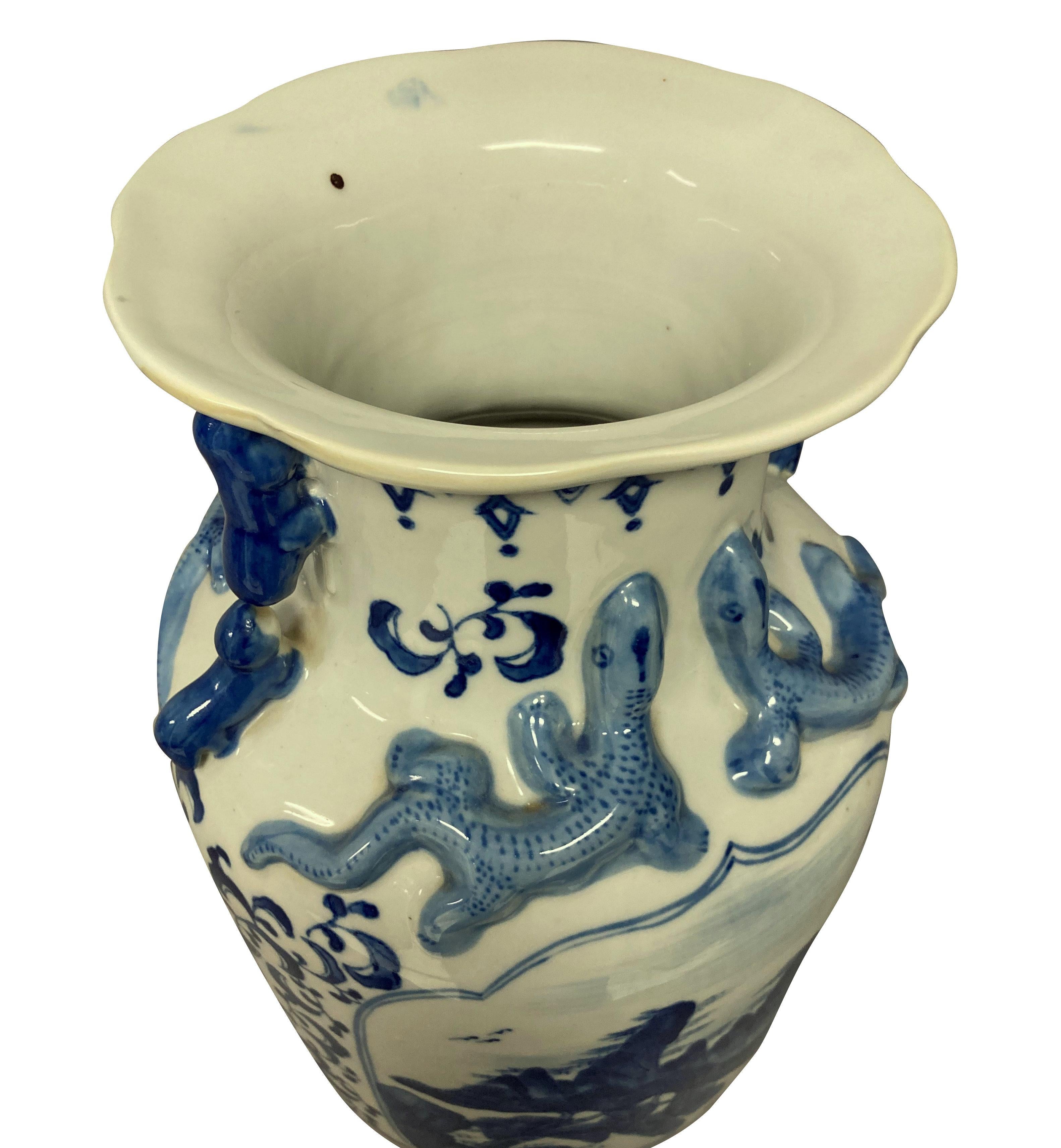 A pair of Chinese blue and white, hand painted porcelain vases. With mountain scenes and salamander decoration.