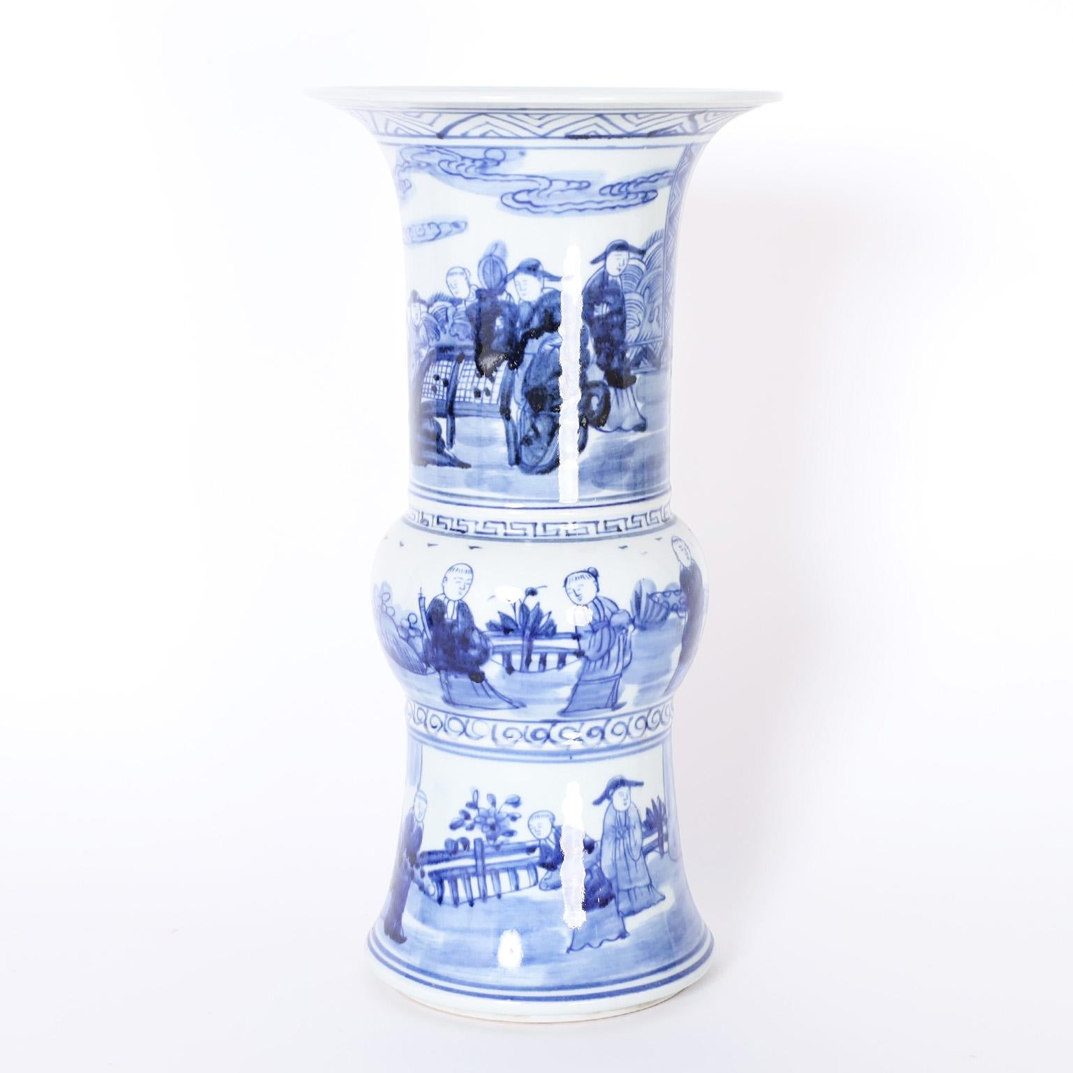 Enchanting pair of Chinese blue and white porcelain vases with classic form. Hand decorated all around with three levels of figures in landscapes.