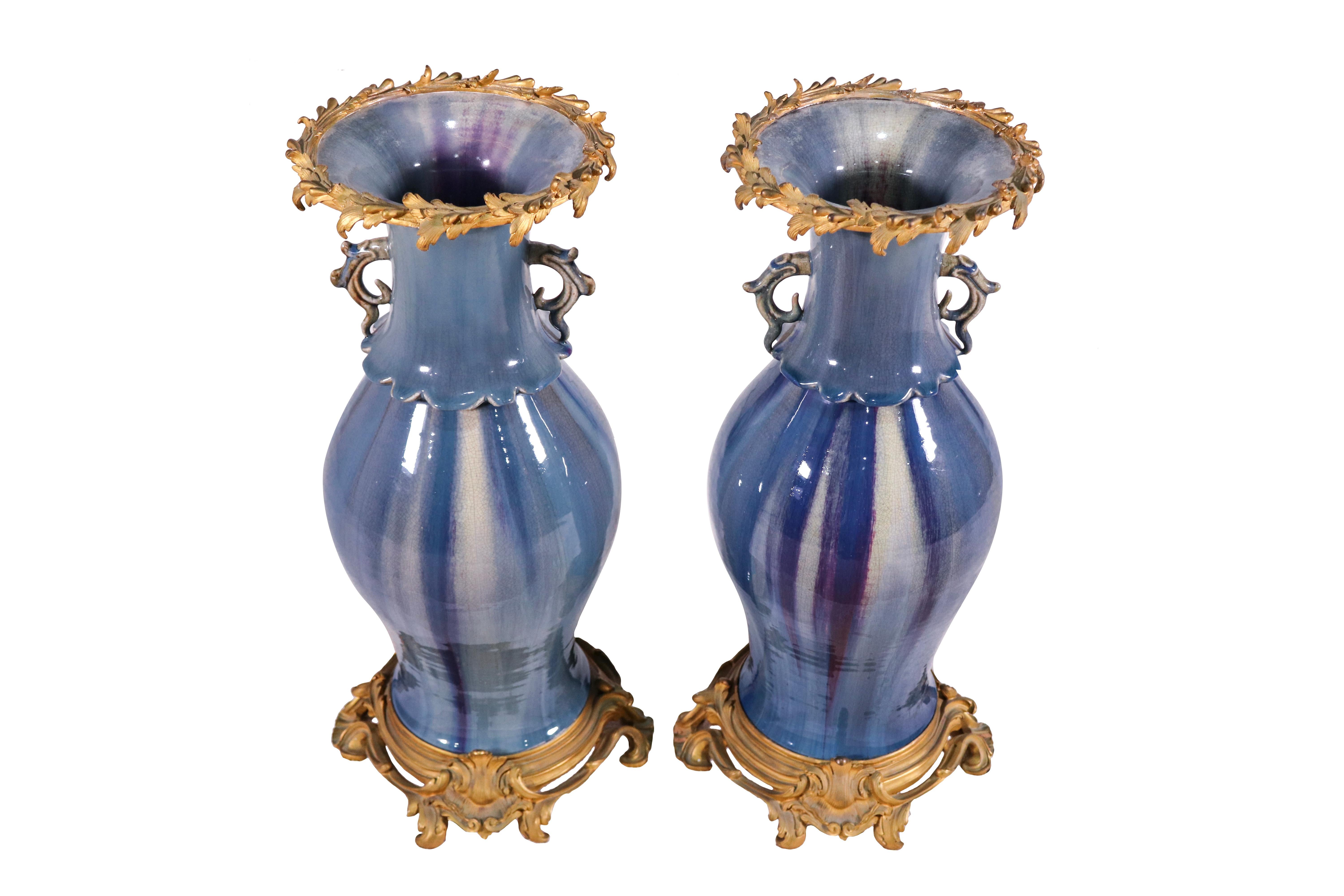 Pair of antique Chinese blue flambé glazed ceramic vases with later French (late 19th century) ormolu mounts – pierced rocaille base and wreath top rim. Two small decorative handles at the neck of the vases. The glazed surface displays minor wear