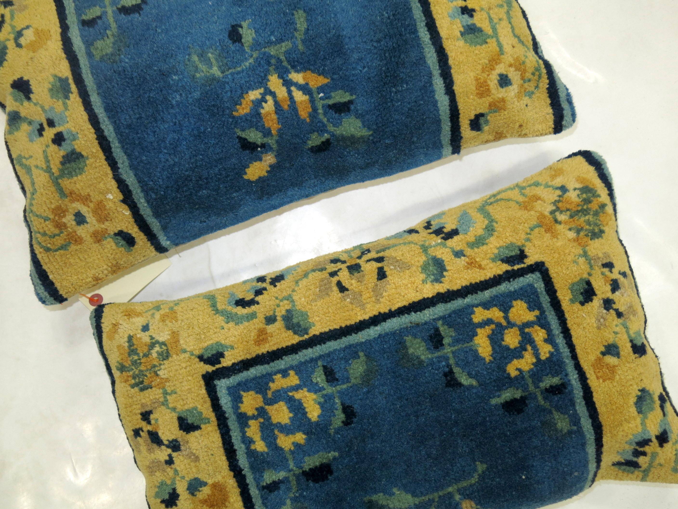 Set of pillows from an early 20th century Chinese in rug in blue and gold each measuring 13'' x 19'' and 14'' x 22''.