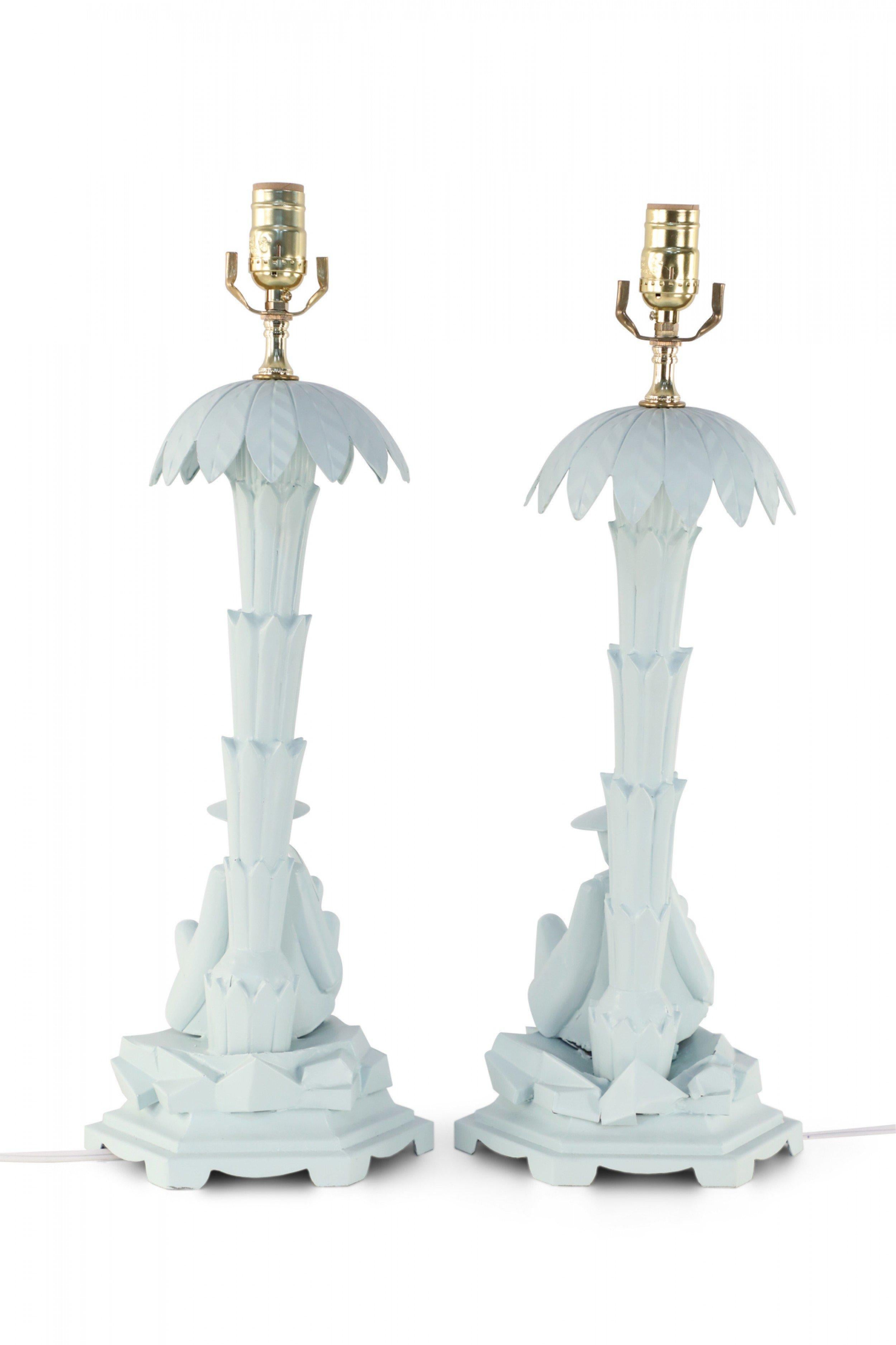Pair of Chinese light blue tole table lamps depicting a man holding a fan sitting in the shade of a palm tree. (PRICED AS PAIR).
 