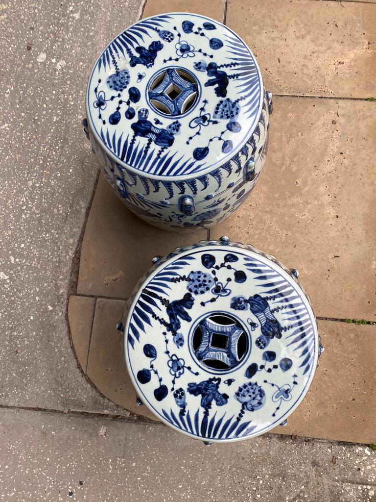 This pair of Chinese Yuan blue and white garden stools are hand painted pierced to the top with fish motif porcelain and 20th century a wonderful addition to your collection of blue and white.