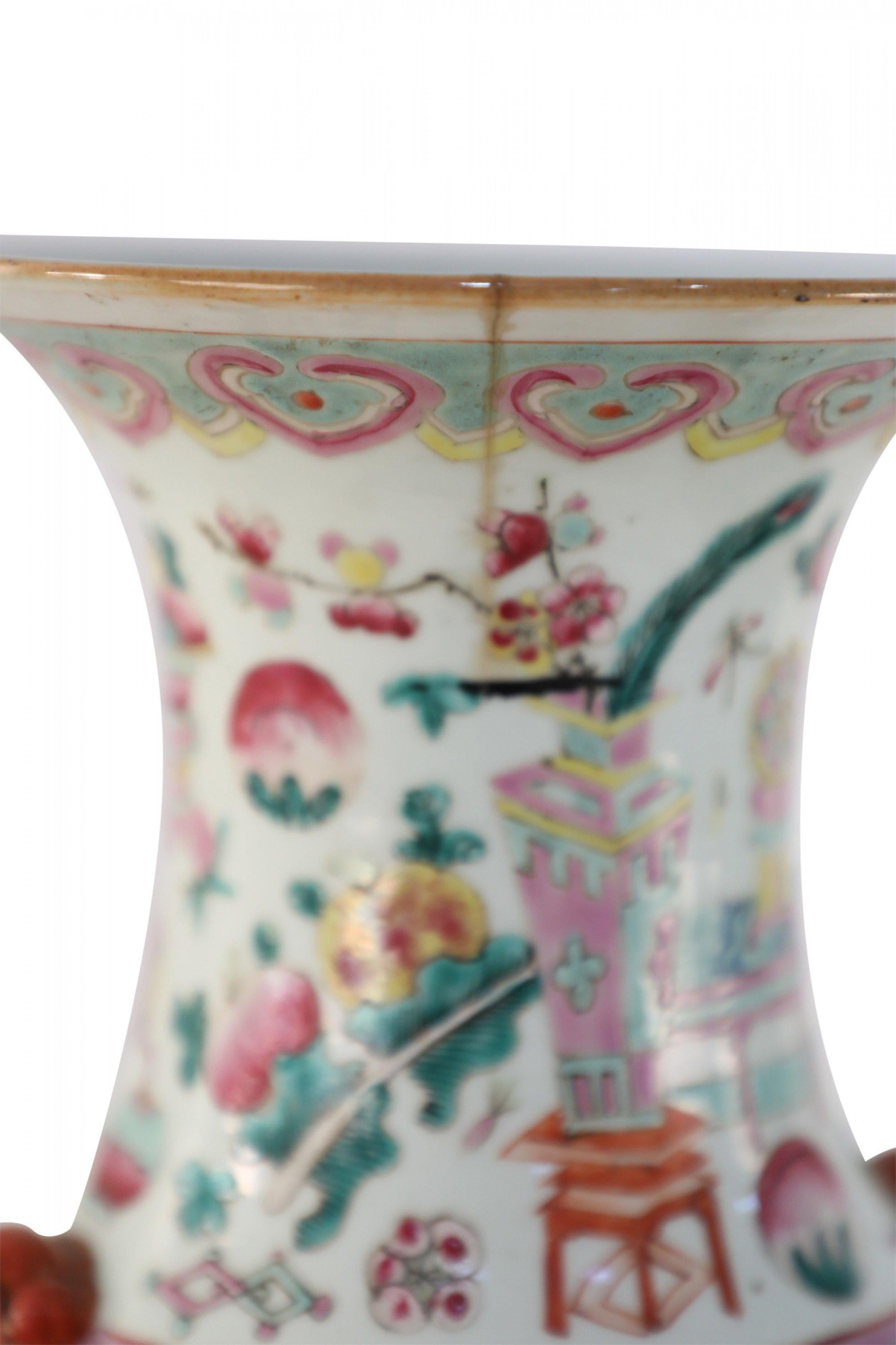 Pair of Chinese (Early 20th century) similar off-white lobed porcelain vases with red foo dog side ornaments and a pink and green traditional bogu pattern featuring bonsai, art objects, and calligraphy. (date mark on bottom) (Priced as Pair).
  