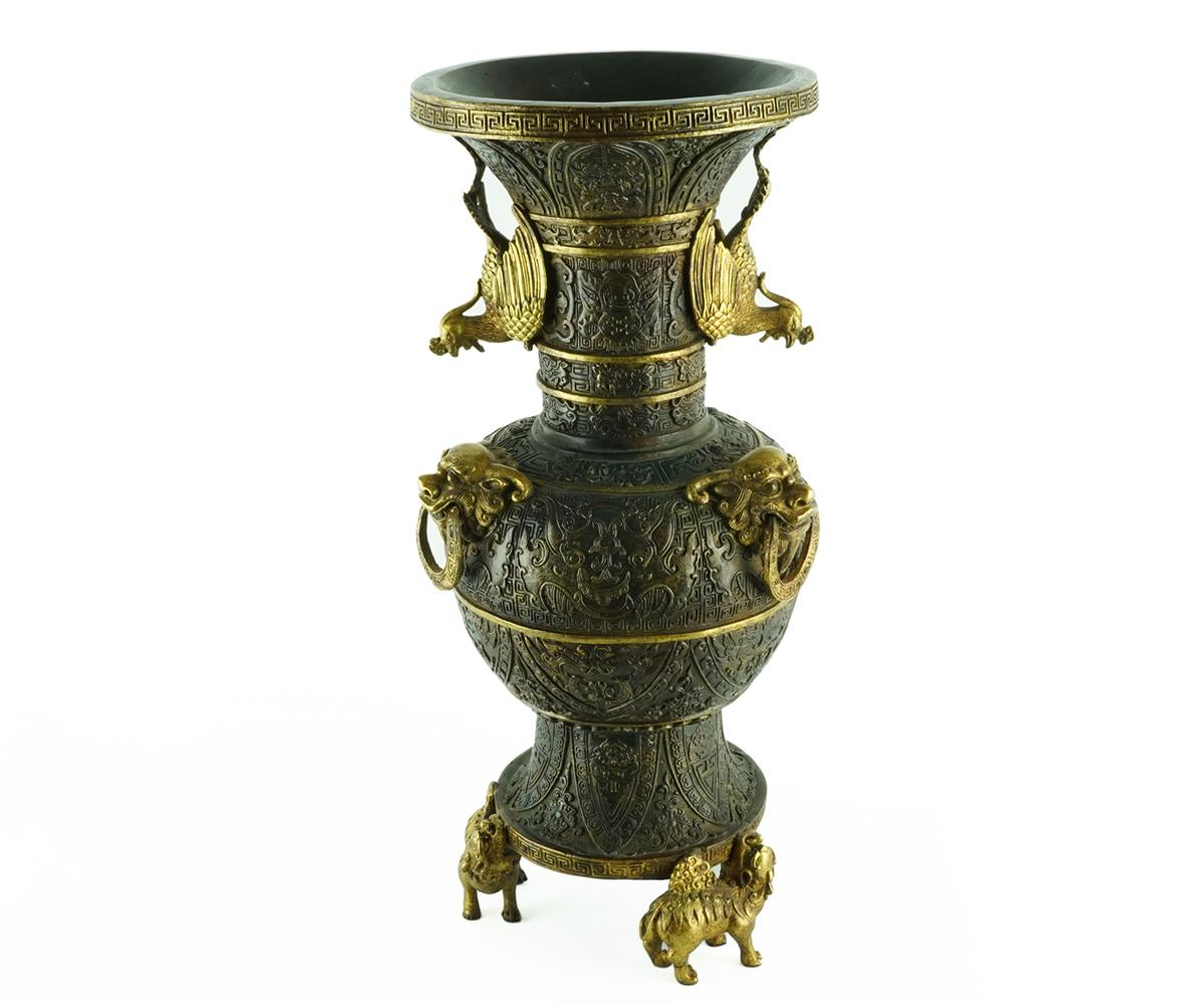 This Chinese pair of bronze vases exhibit an unusually high amount of detail with virtually the entire surface being decorated. The top of the vases feature two gilt bronze phoenix as handles, the bulbous centre of the vase has three gilt bronze foo