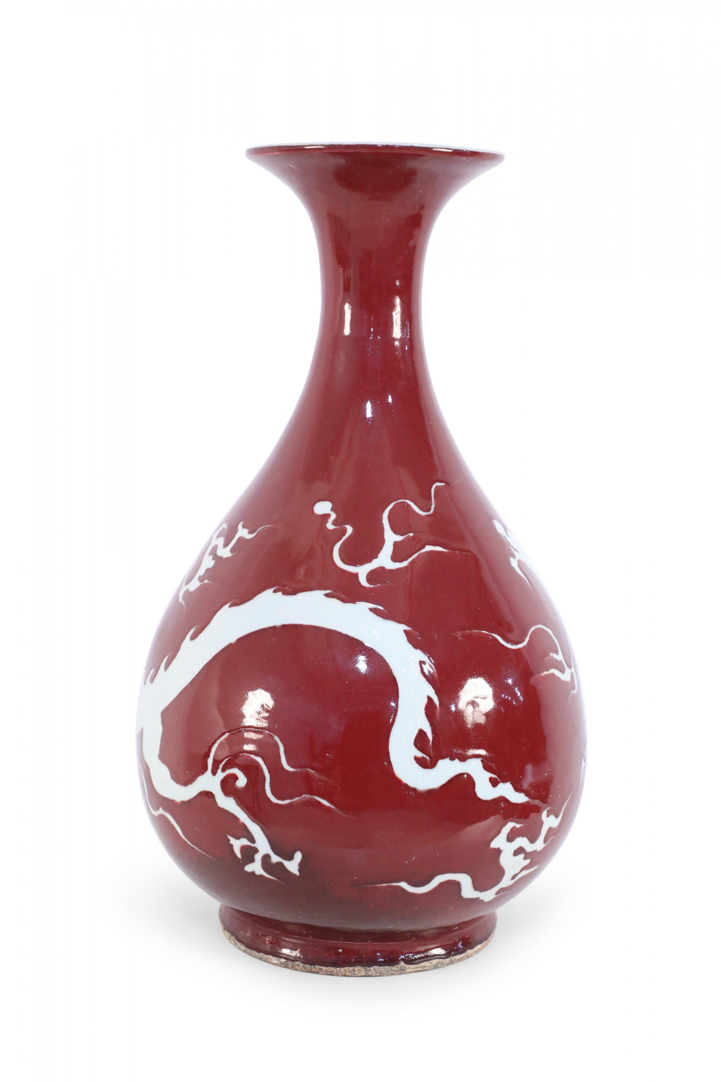 Porcelain Pair of Chinese Burgundy and White Dragon Motif Vases