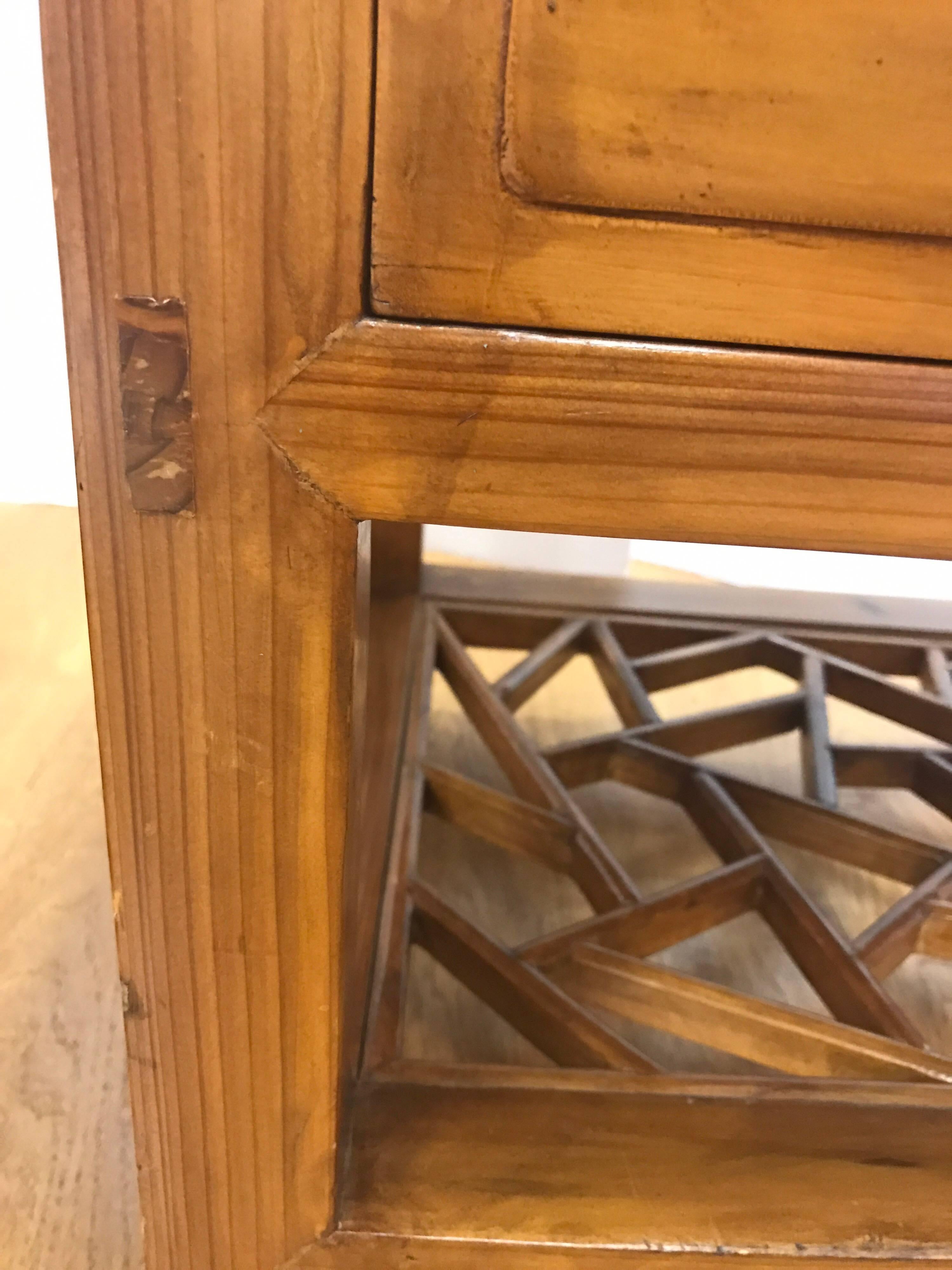 Pair of Chinese three-drawer nightstands or end tables made of camphor wood. Bottom shelving has an open work pattern.