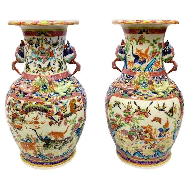 A very good quality pair of 19th century Chinese rose medallion vases, each with wonderful bold pinks, blues and green coloring, exotic bird handles on either side, lizards circling the necks, painted inset panels depicting mythical creatures.
We