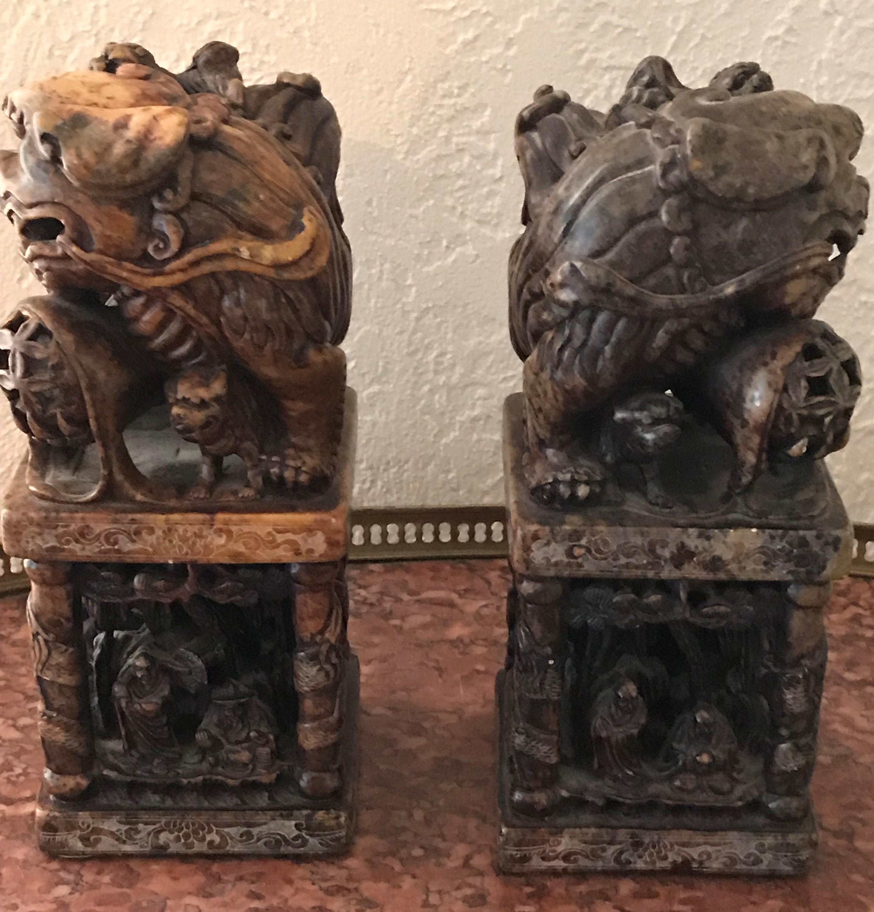 Pair of foo dog seal chops. Chinese hardstone carved with Buddhist monks in forest scene in base, circa 1900.

9