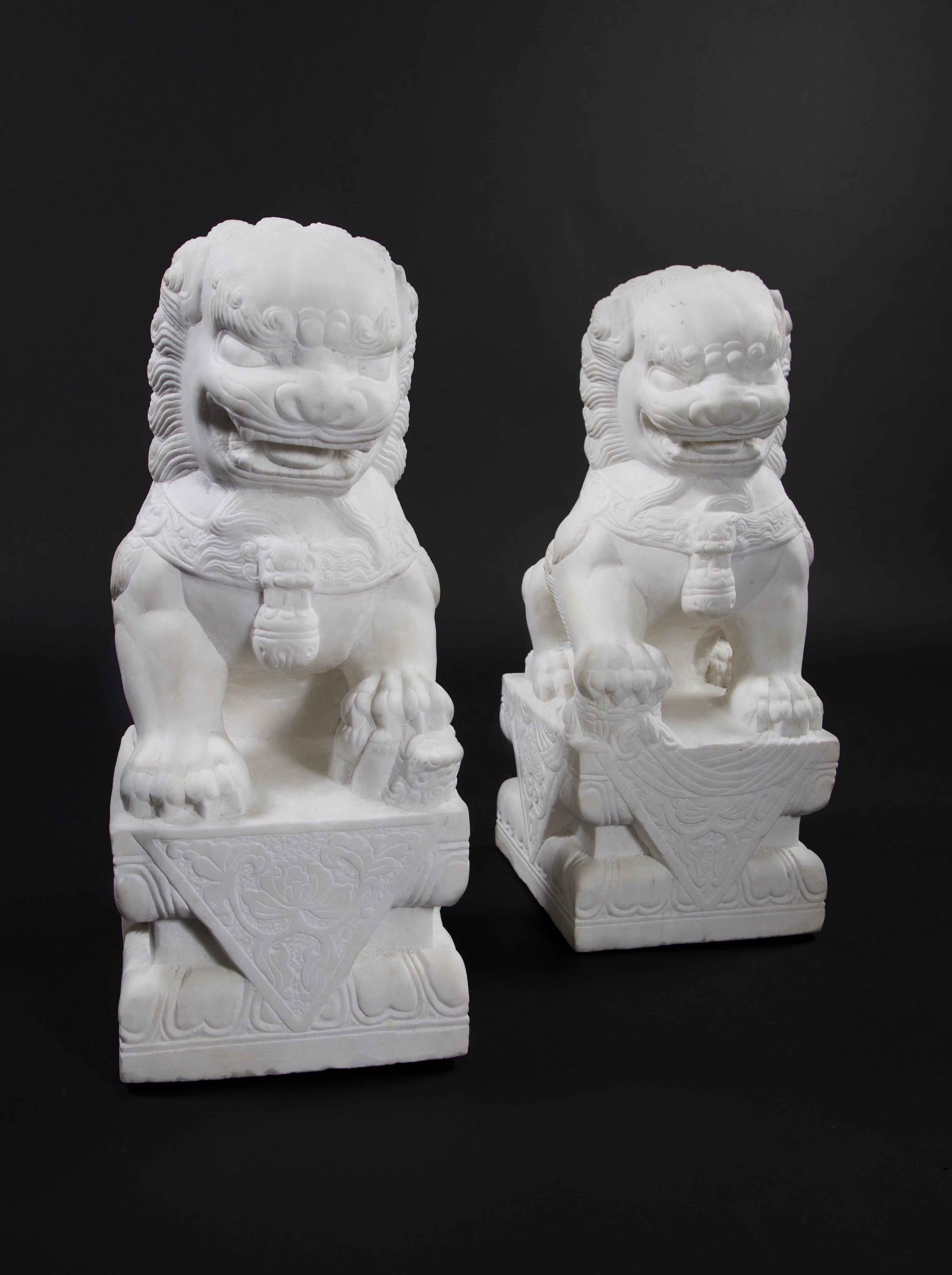Large and heavy pair of Chinese carved marble foo dogs from a block of marble.